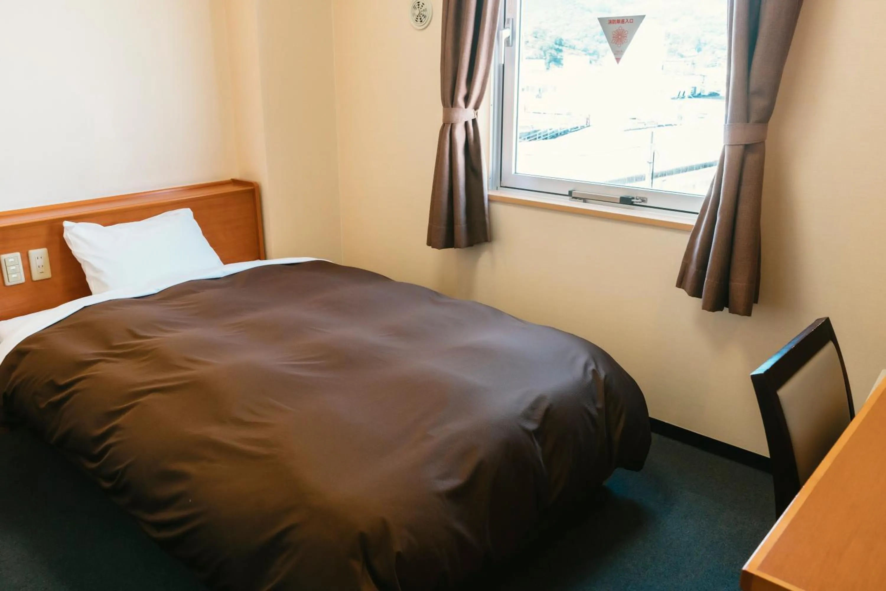 Bed in Kumamoto Ichibamae Business Kurenai Hotel