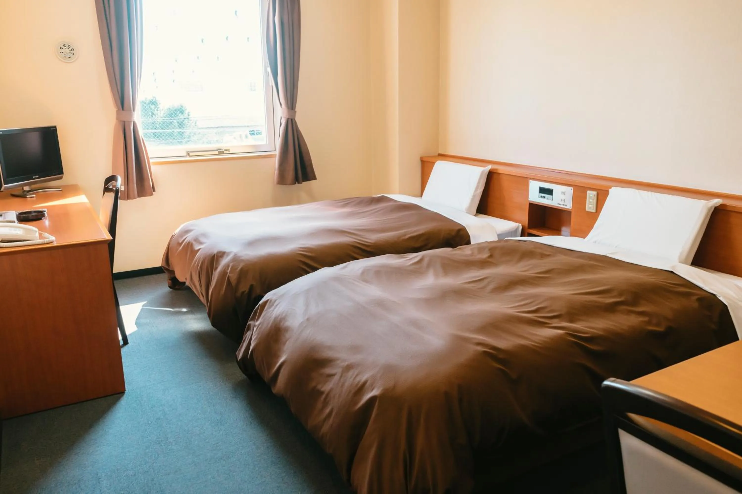 Bed in Kumamoto Ichibamae Business Kurenai Hotel