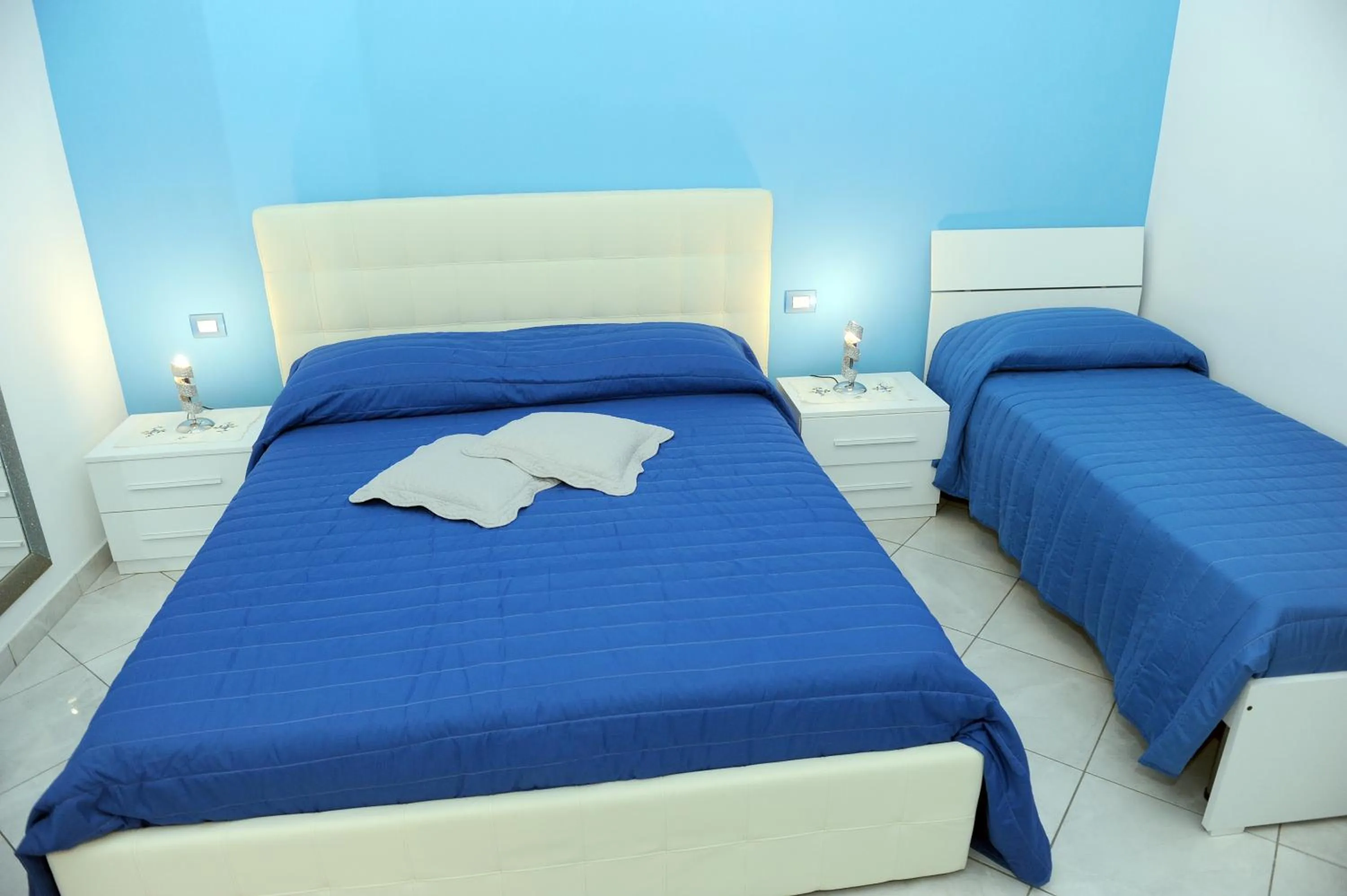 Bed in L'Isola Del Postino Rooms