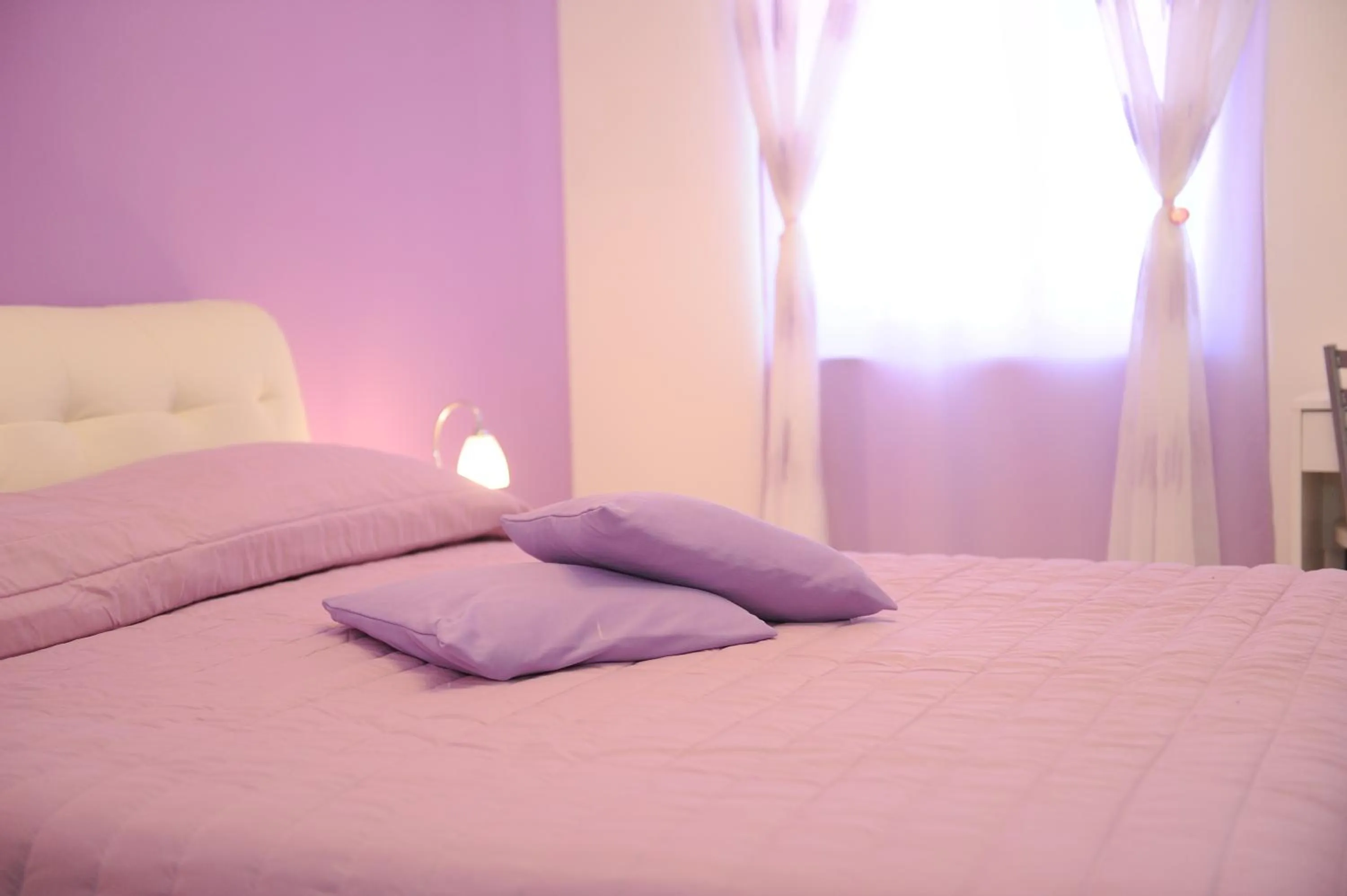 Bed in L'Isola Del Postino Rooms