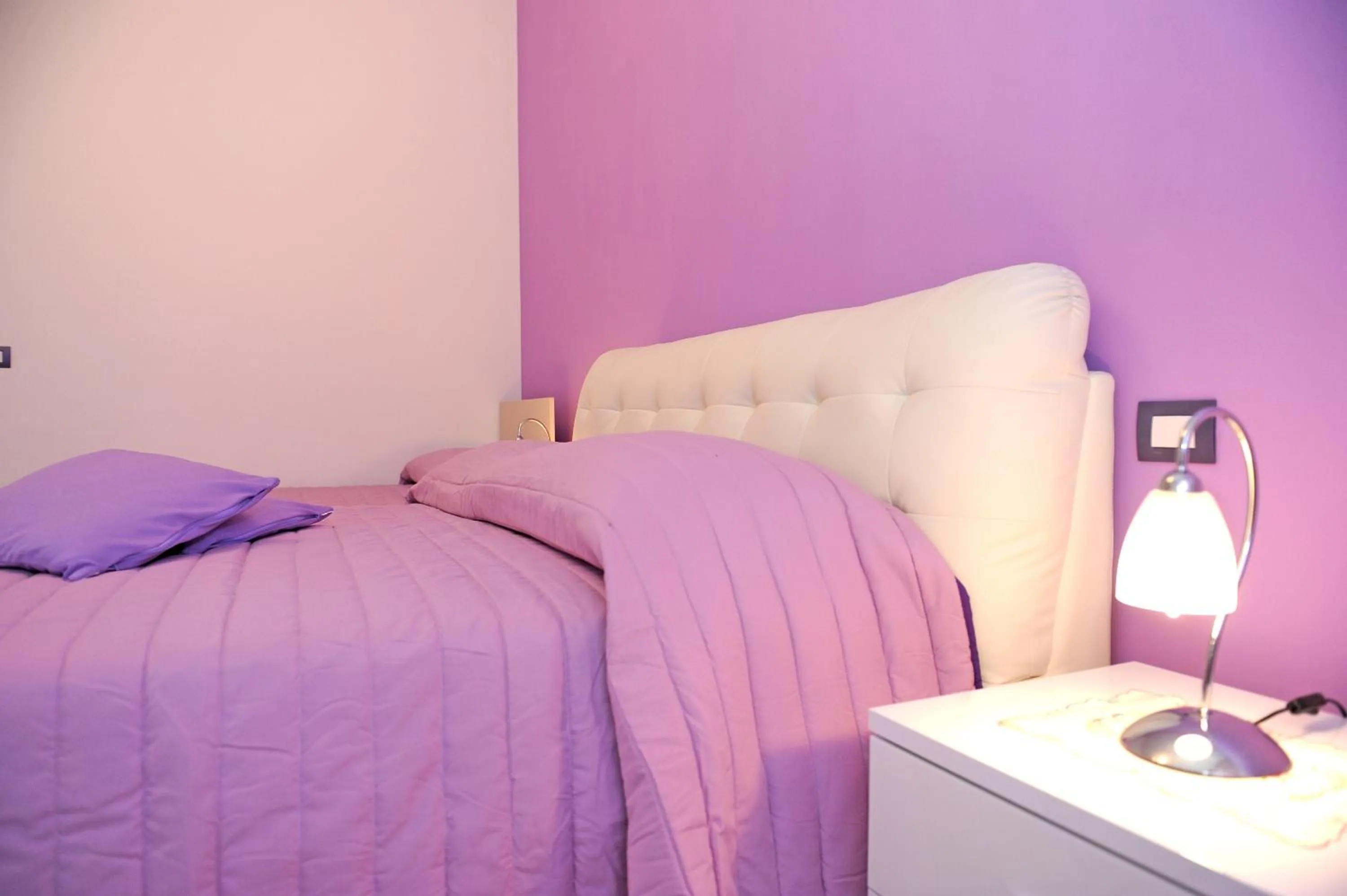 Bed in L'Isola Del Postino Rooms