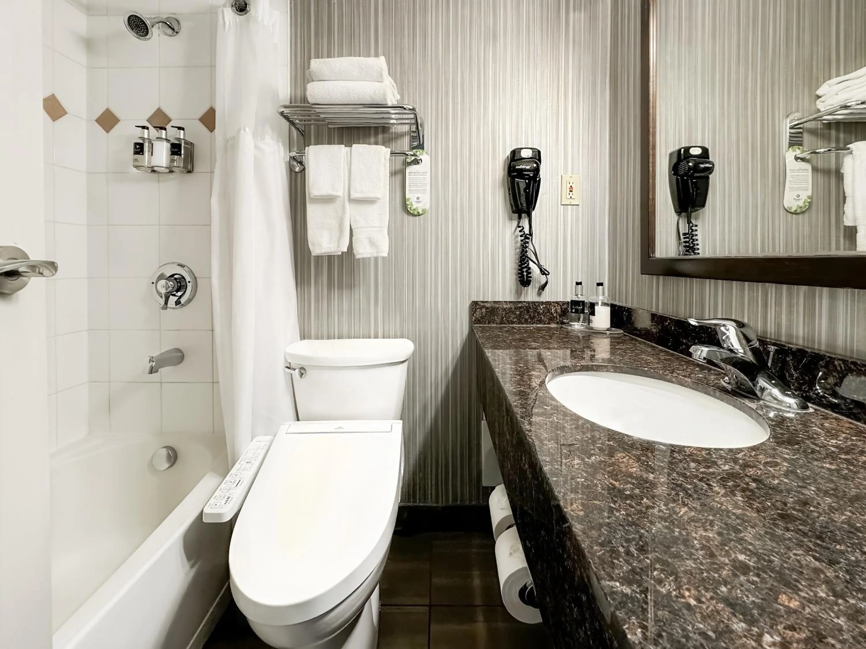 Bathroom in Coast Calgary Downtown Hotel & Suites by APA
