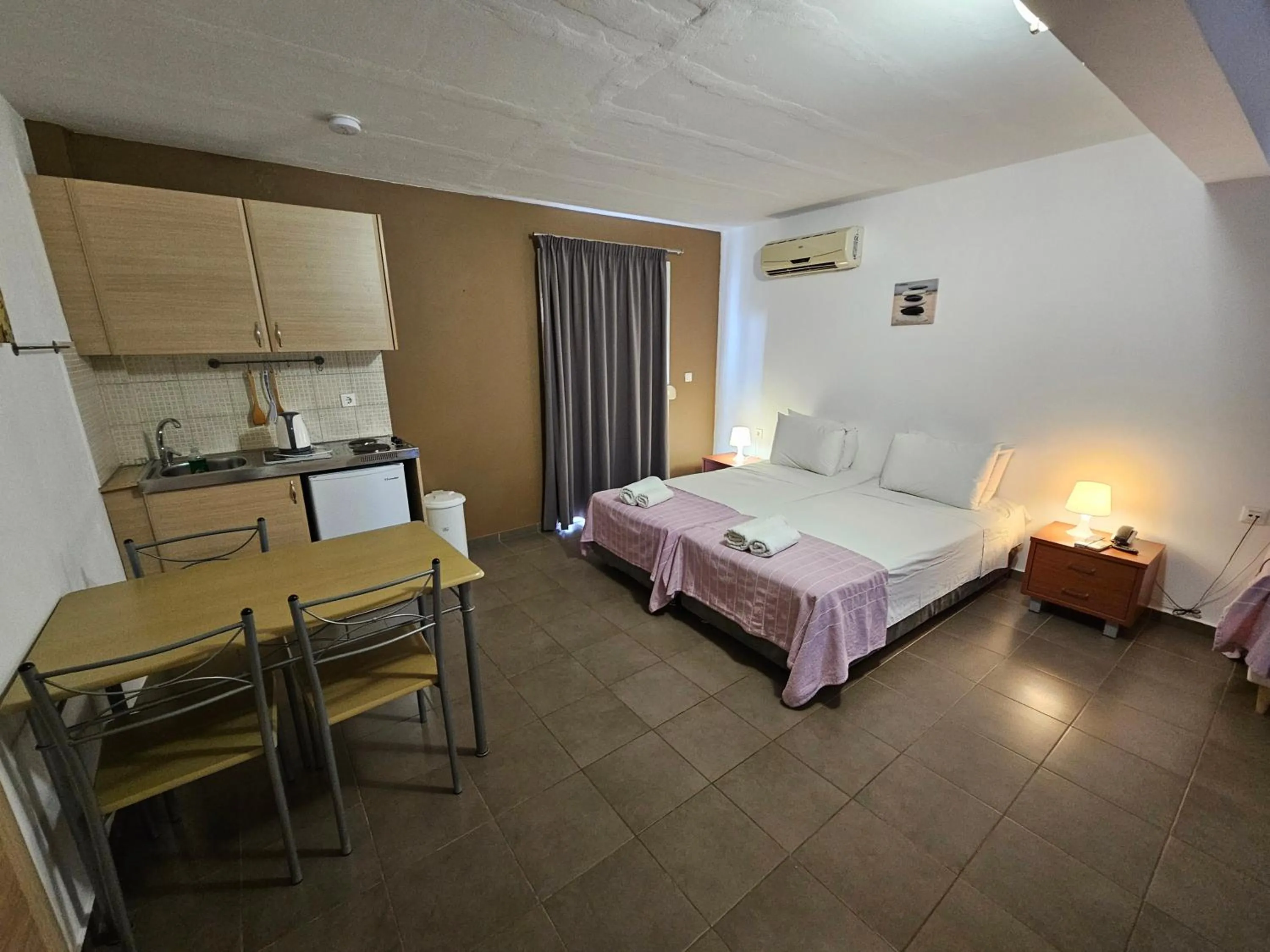 Bed in Elounda Sunrise Apartments