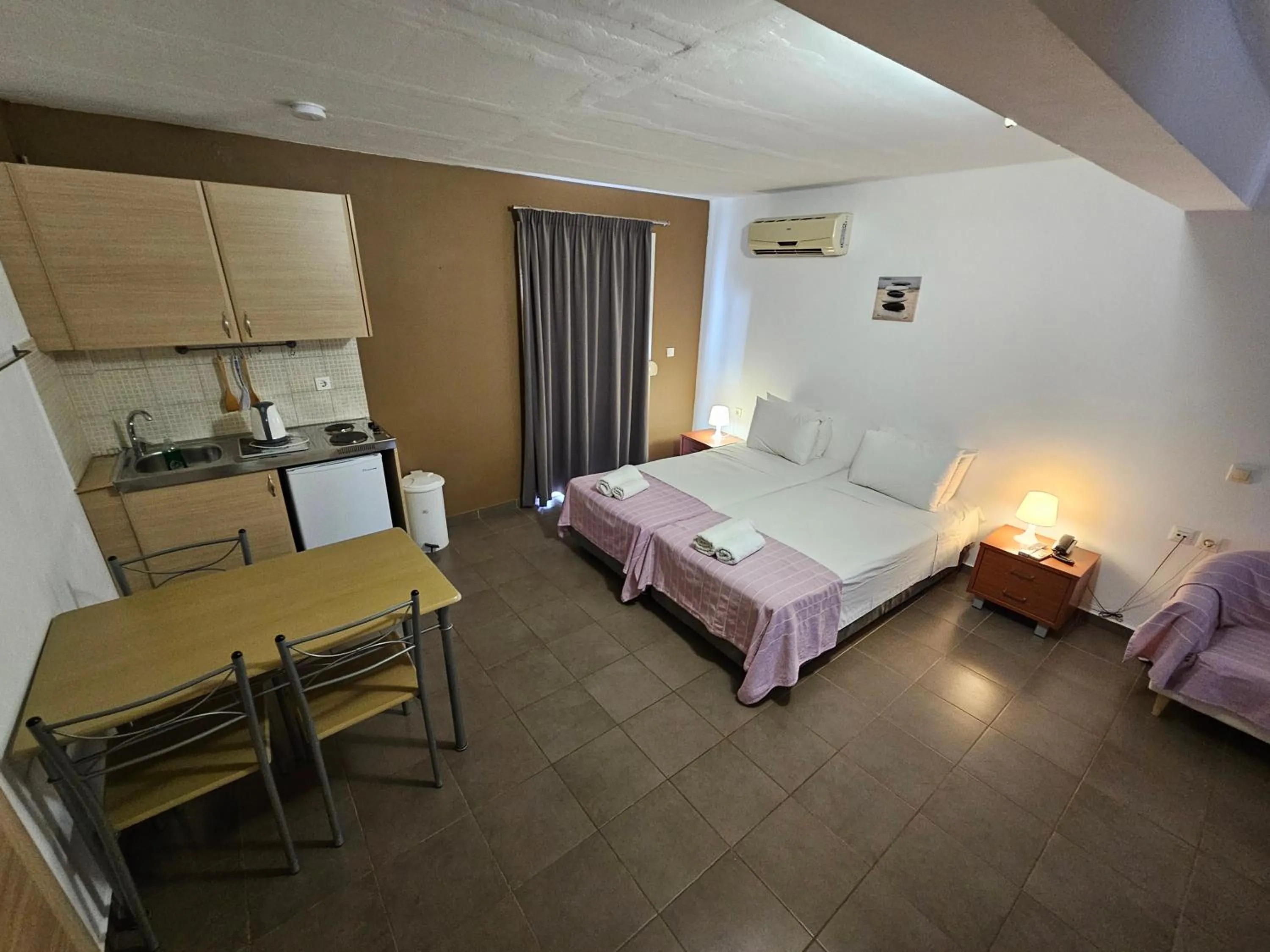 Bed in Elounda Sunrise Apartments