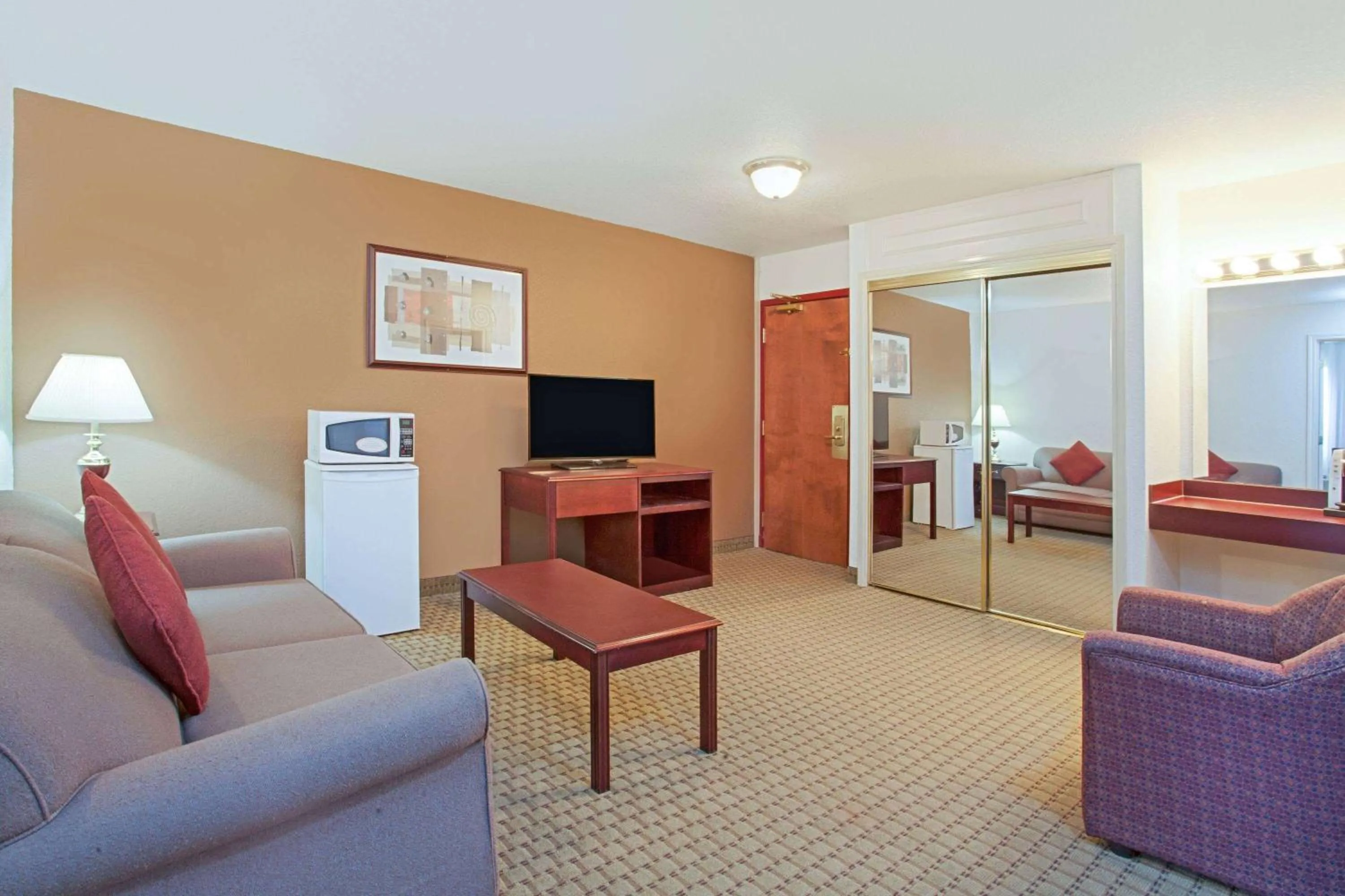 Living room in Ramada by Wyndham Red Deer Hotel & Suites
