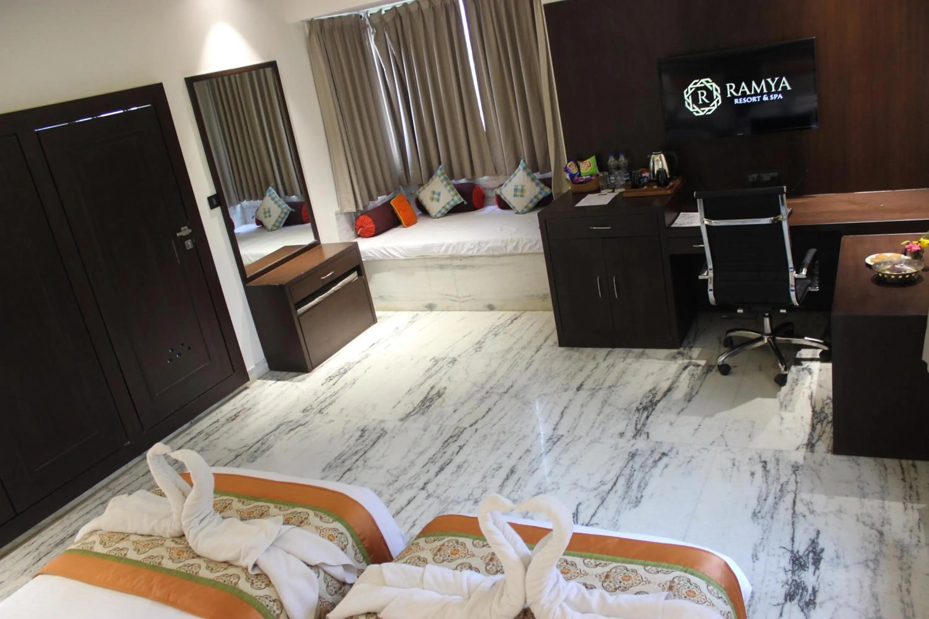 Seating area, Bed in Ramya Resort & Spa