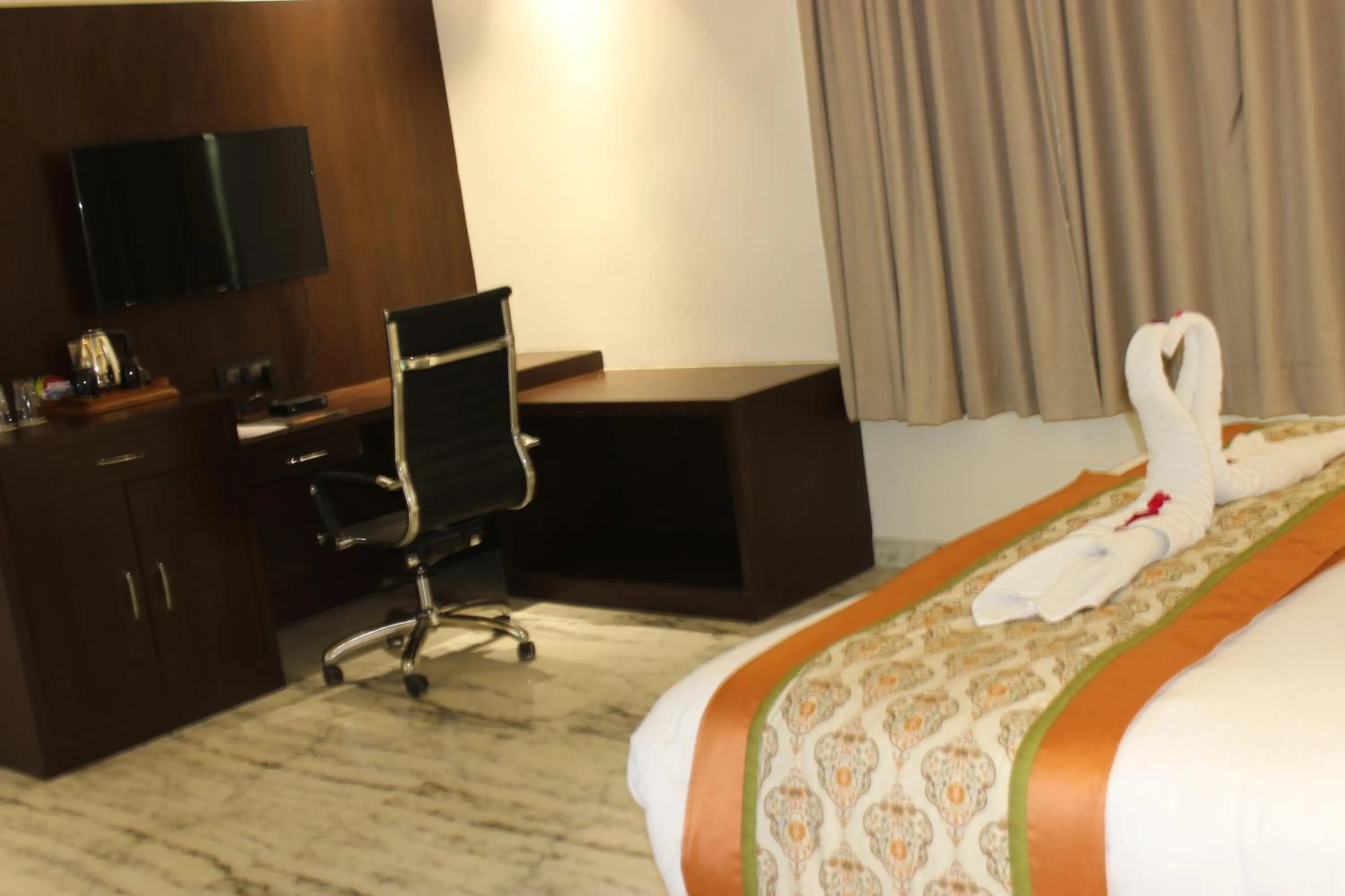 Seating area, Bed in Ramya Resort & Spa