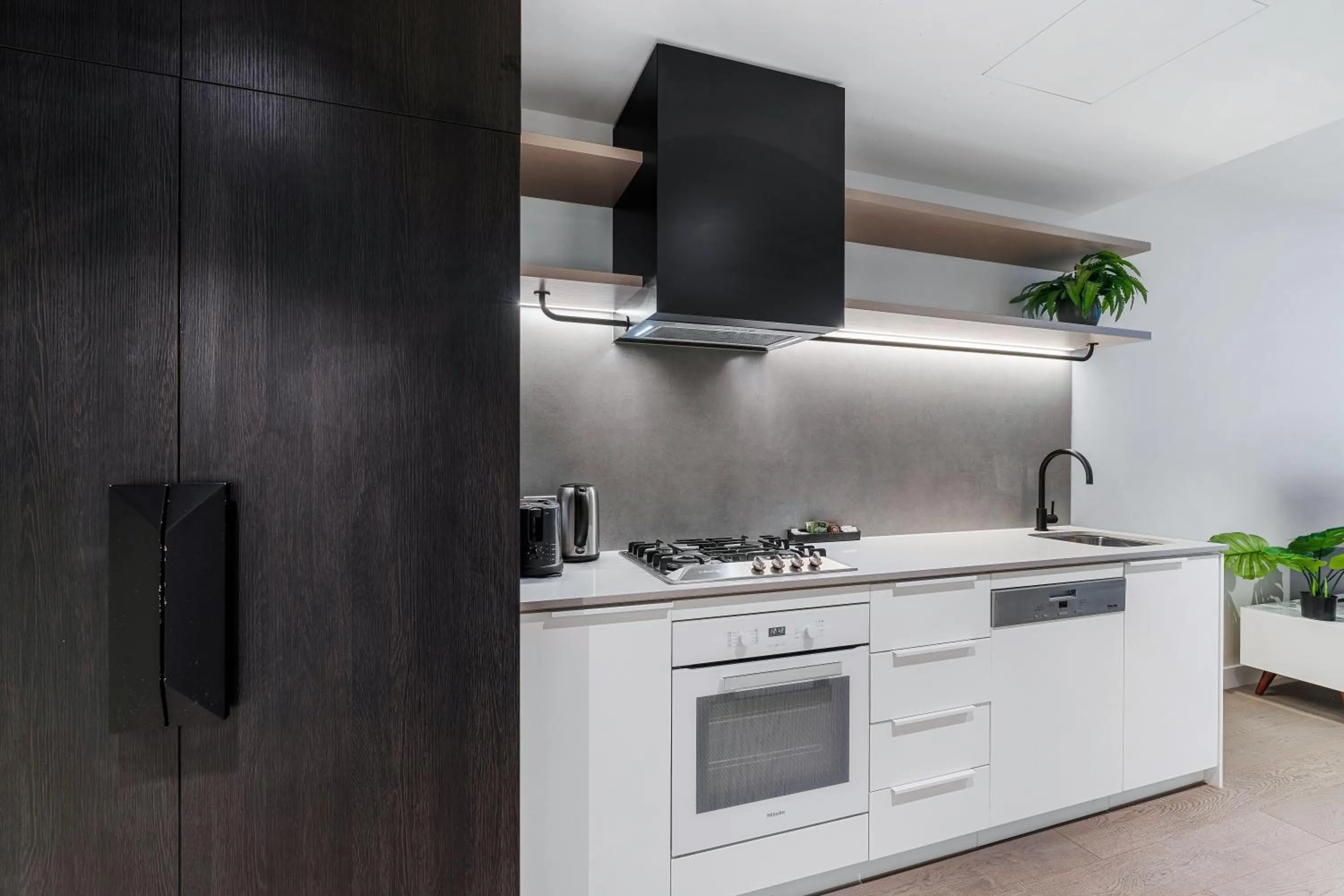 Kitchen or kitchenette in The Eminence Apartments by CLLIX