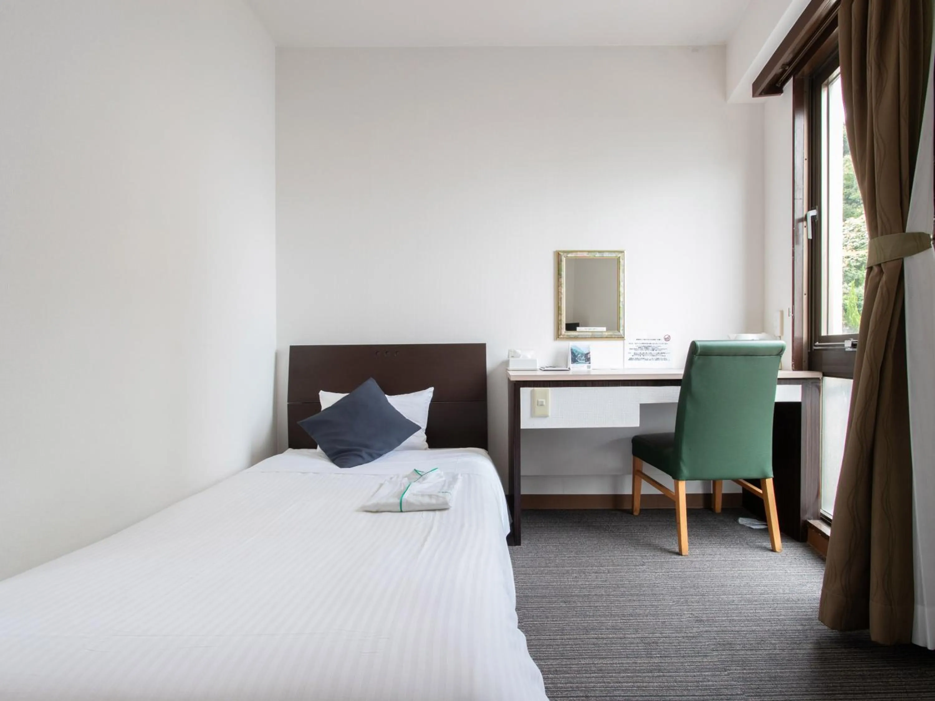 Bed in Tabist Sasebo Palace Hotel