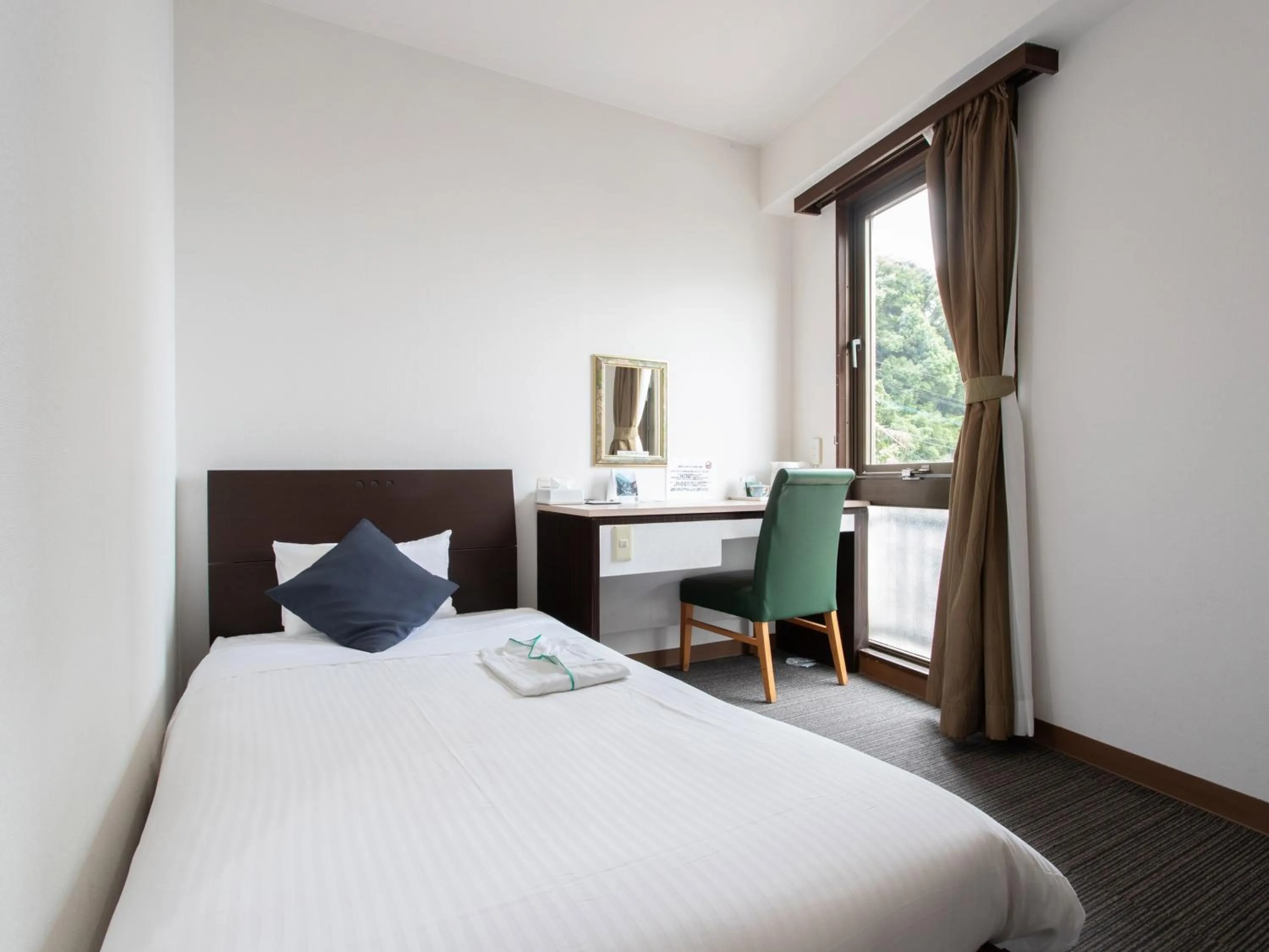 Bed in Tabist Sasebo Palace Hotel