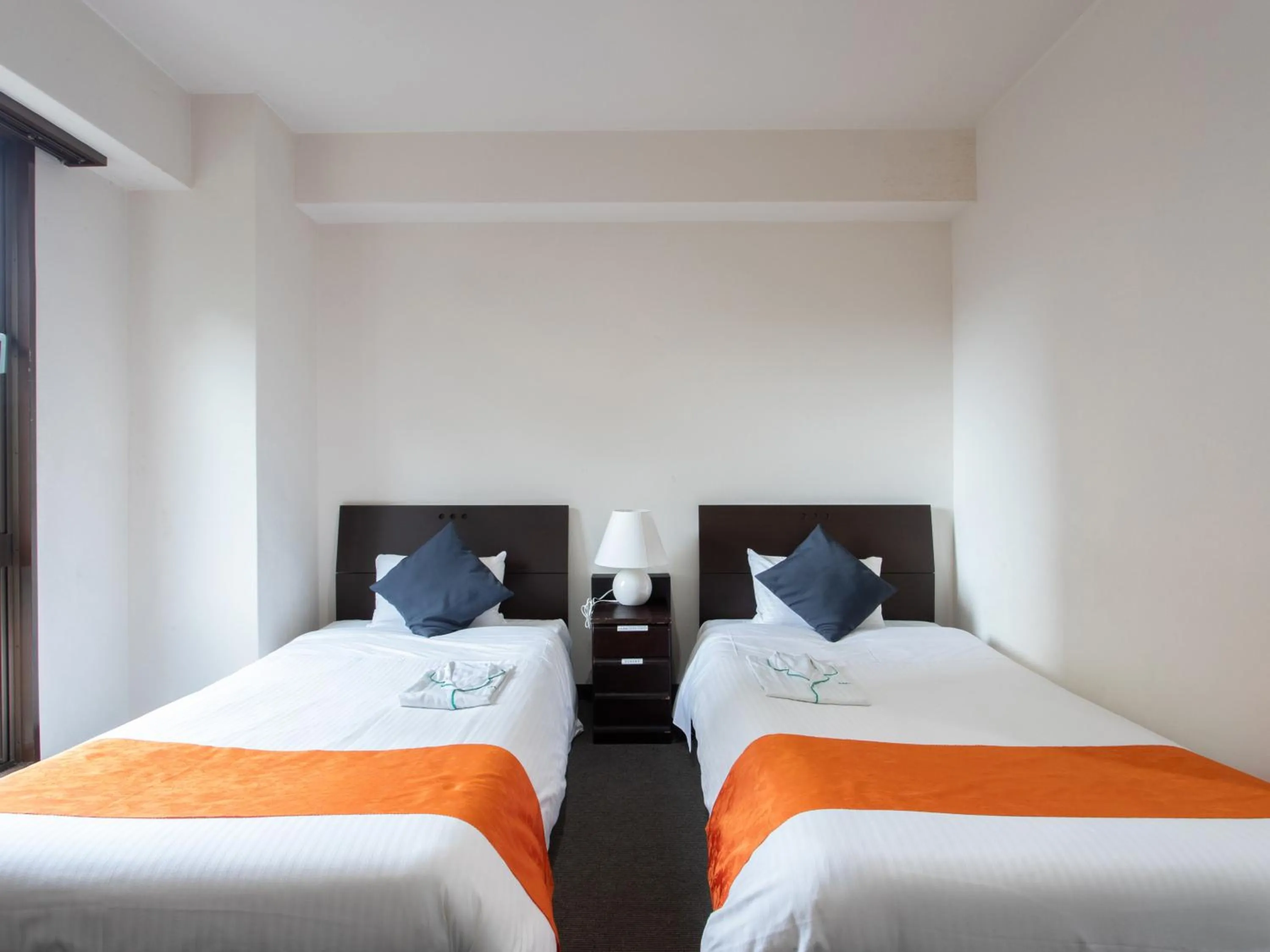 Bed in Tabist Sasebo Palace Hotel