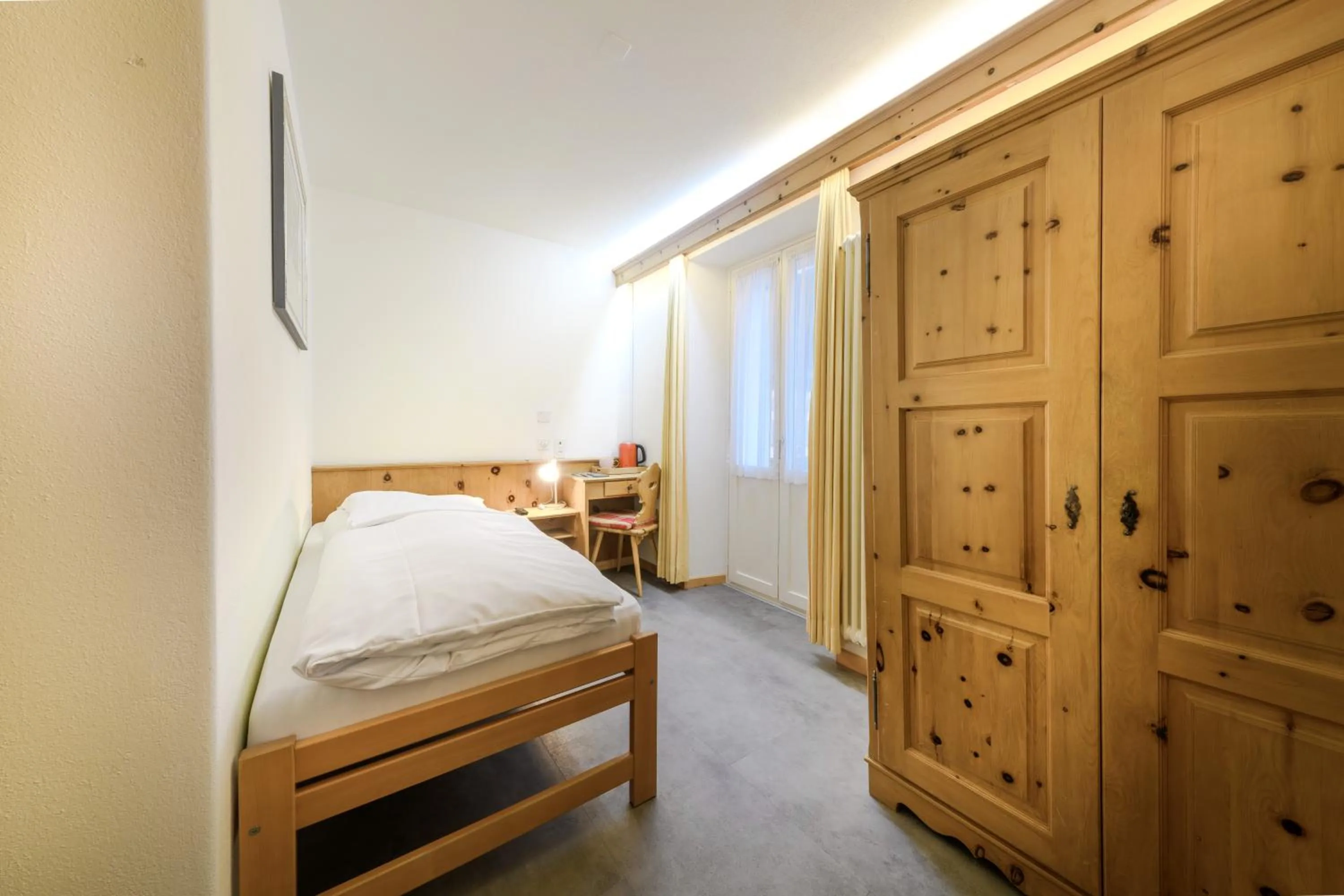 Bed in Poschiavo Suisse Hotel