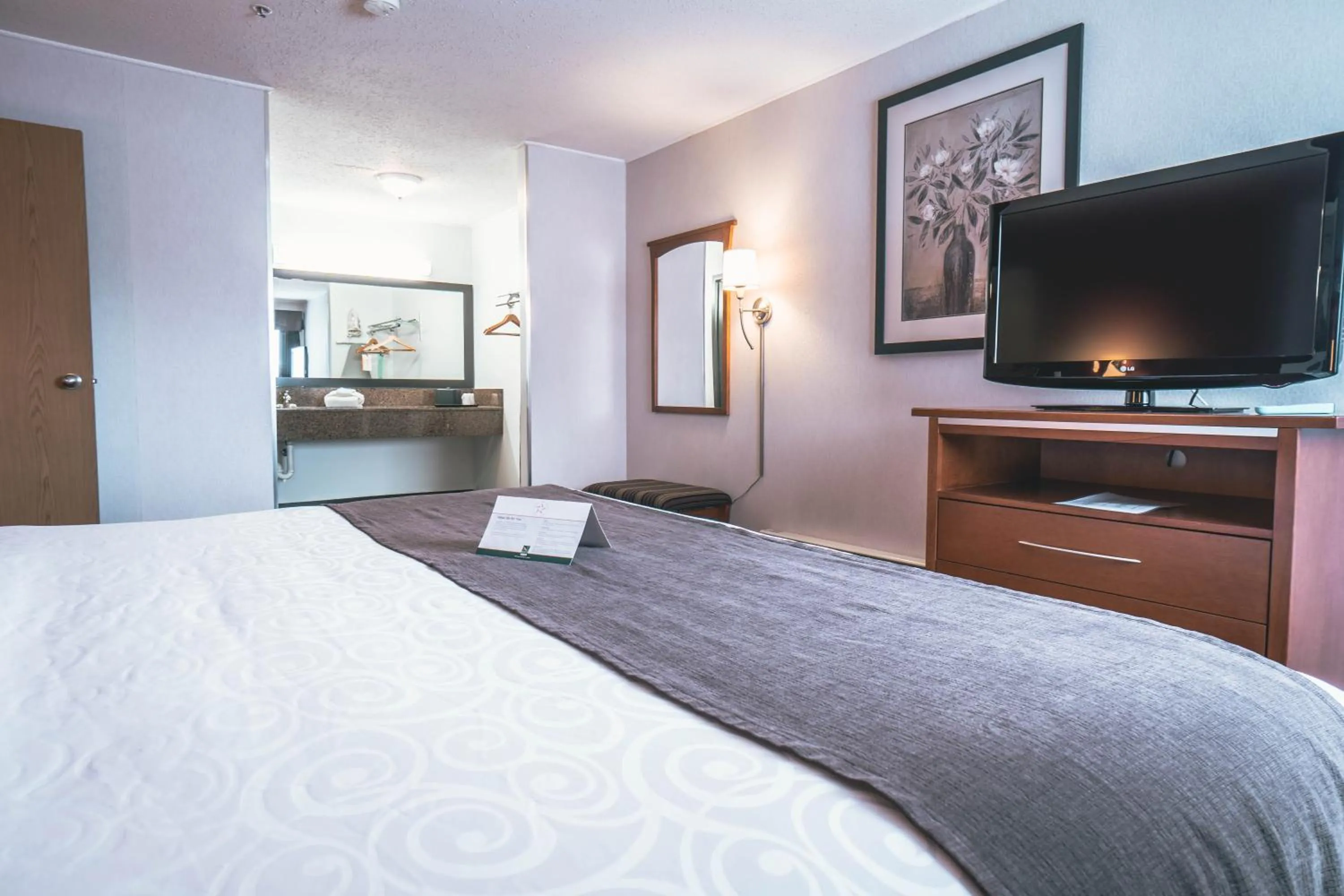 Bed in Quality Inn & Suites