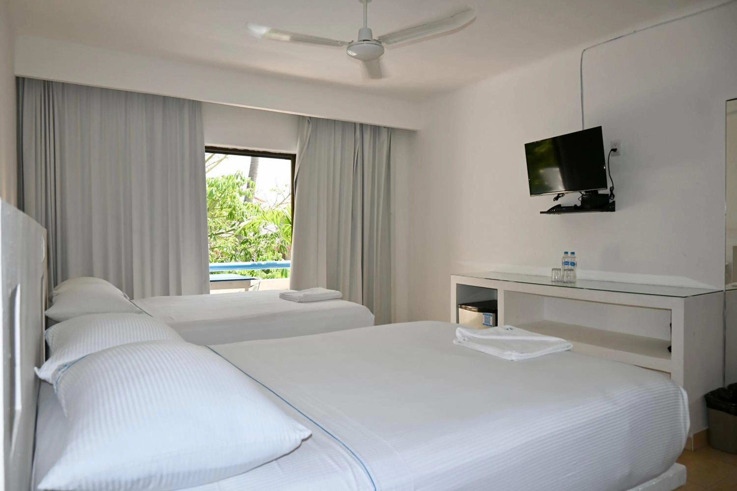 Bed in Pelicano Inn Playa del Carmen - Beachfront Hotel