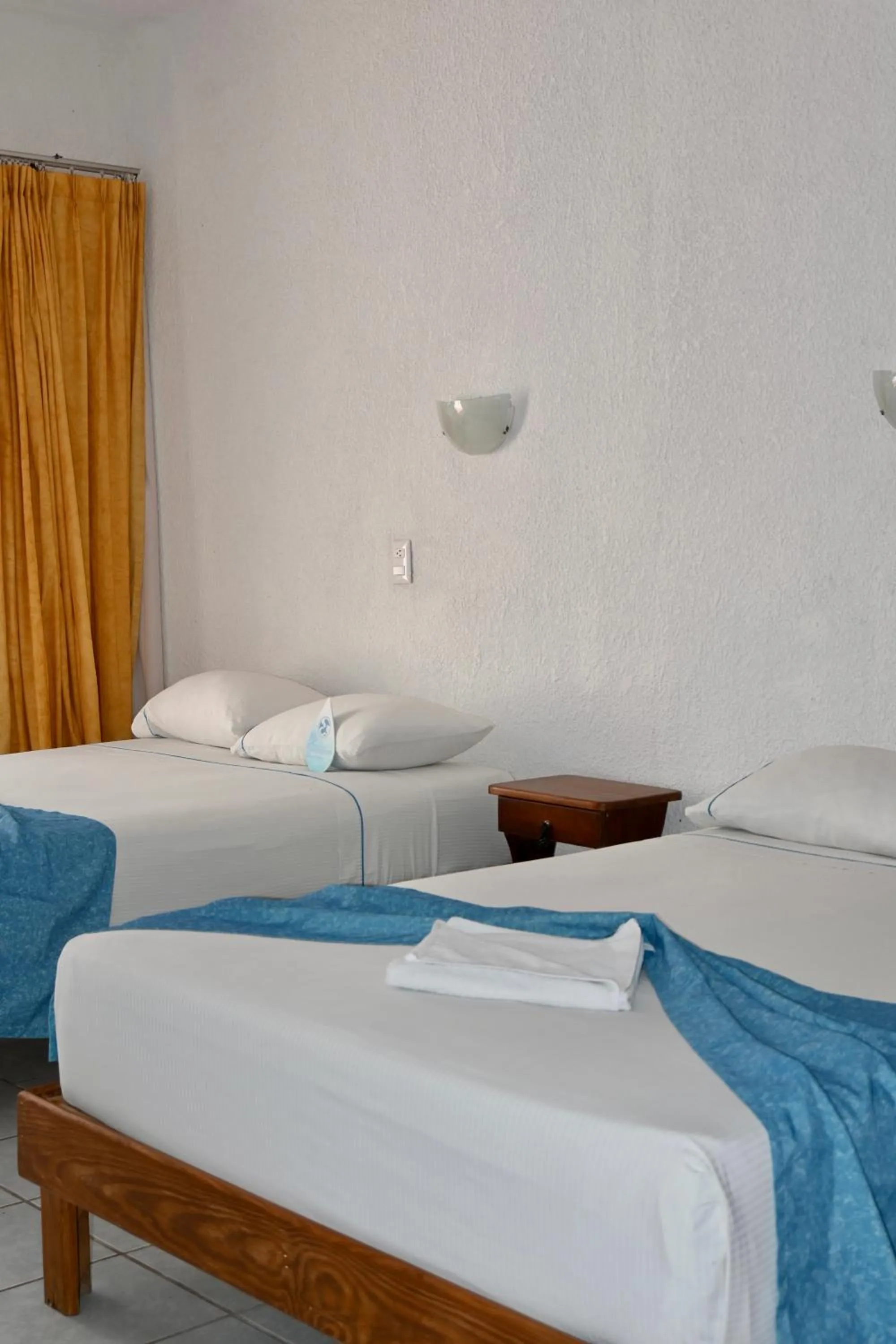 Bed in Pelicano Inn Playa del Carmen - Beachfront Hotel