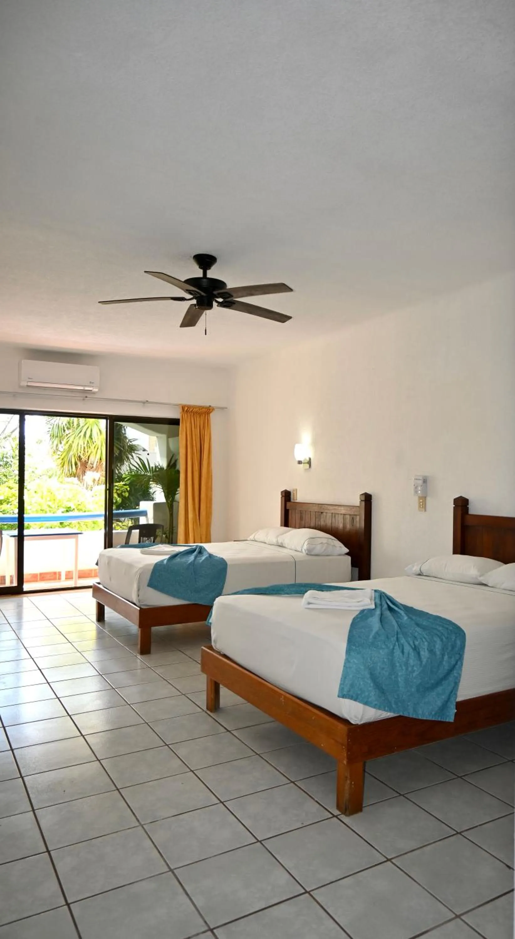 Bed in Pelicano Inn Playa del Carmen - Beachfront Hotel