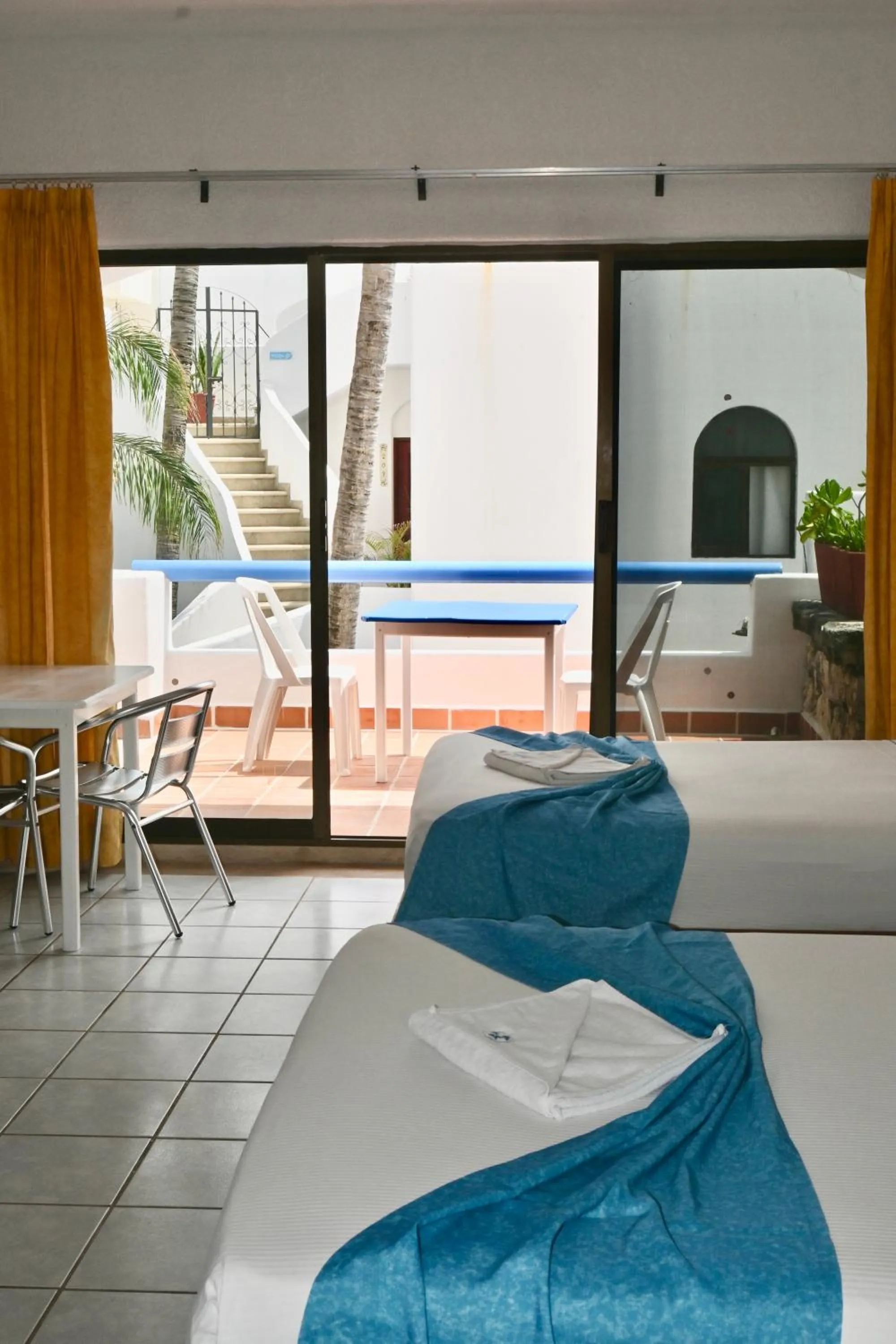 Patio, Bed in Pelicano Inn Playa del Carmen - Beachfront Hotel