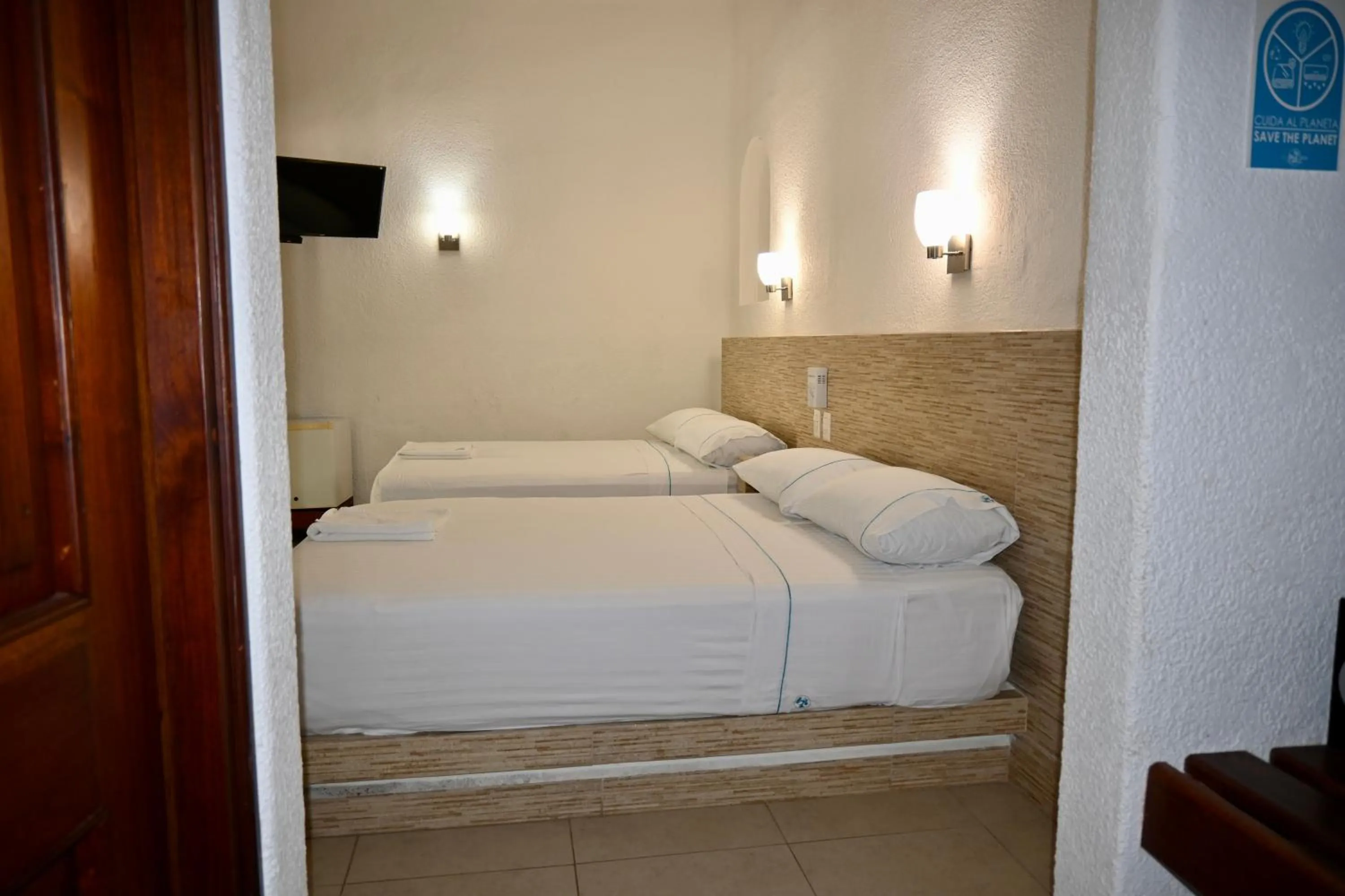 Bed in Pelicano Inn Playa del Carmen - Beachfront Hotel
