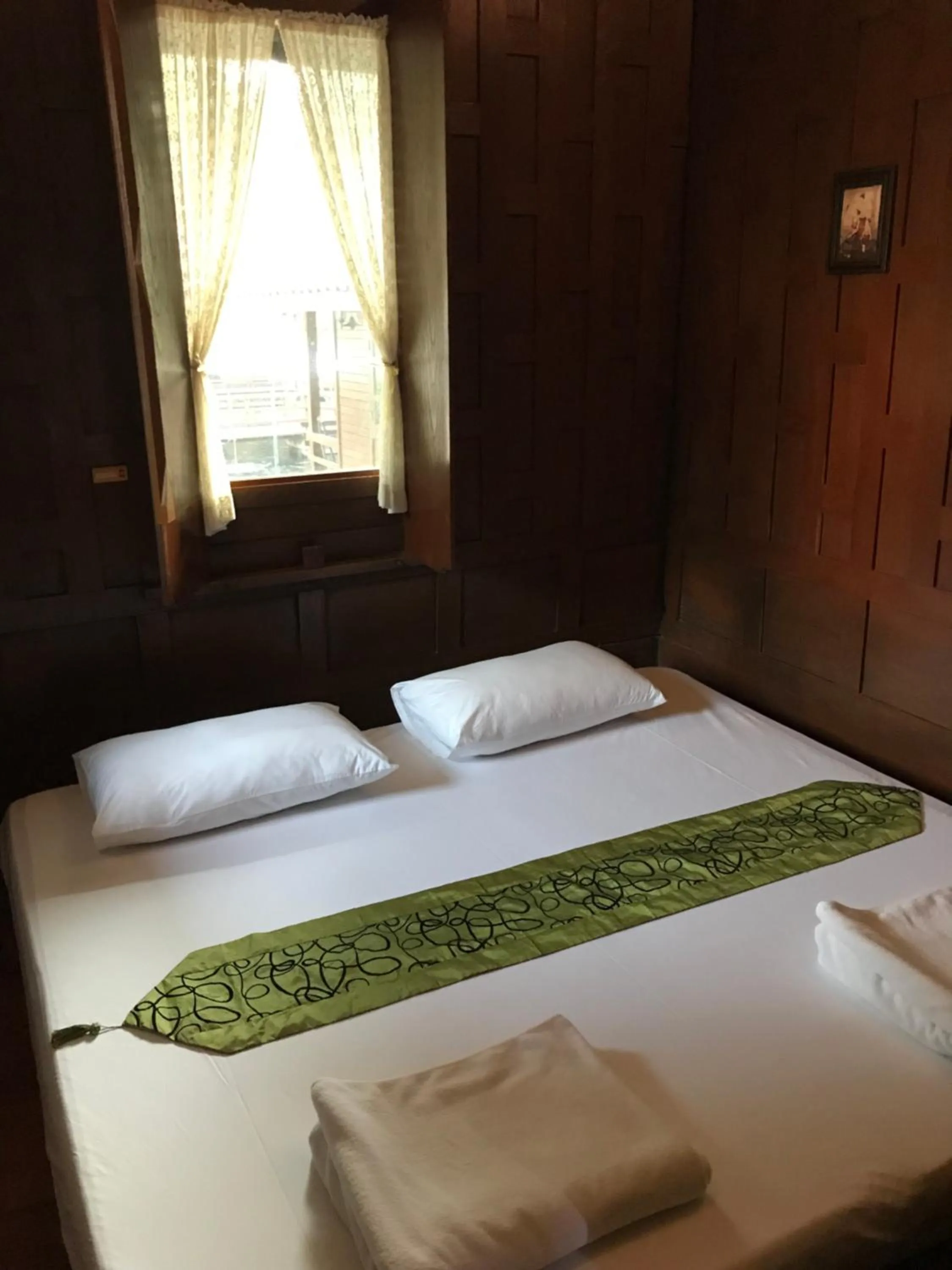 Bed in บ้านกรนรา Baan Kornnara