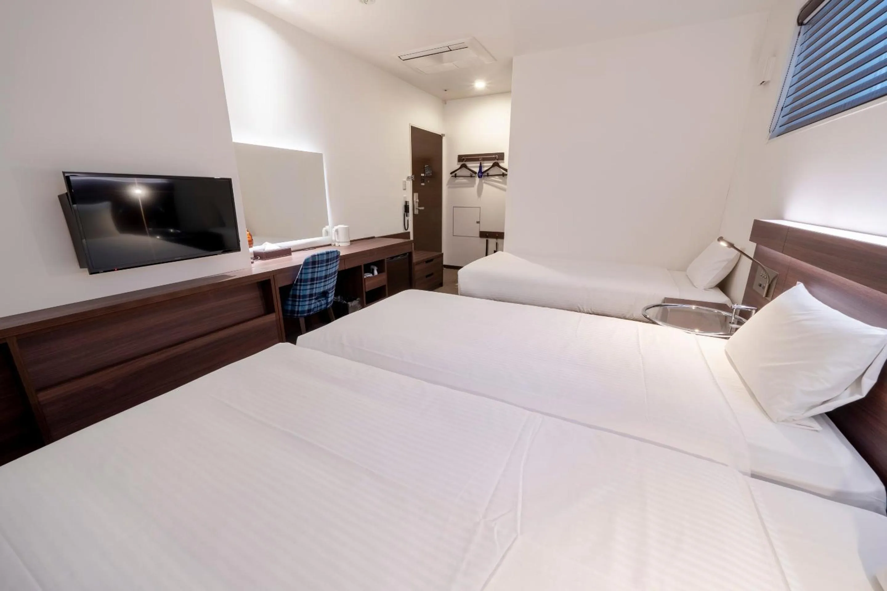 Bed in RESI STAY Jisco Hotel Kyoto Goshonishi