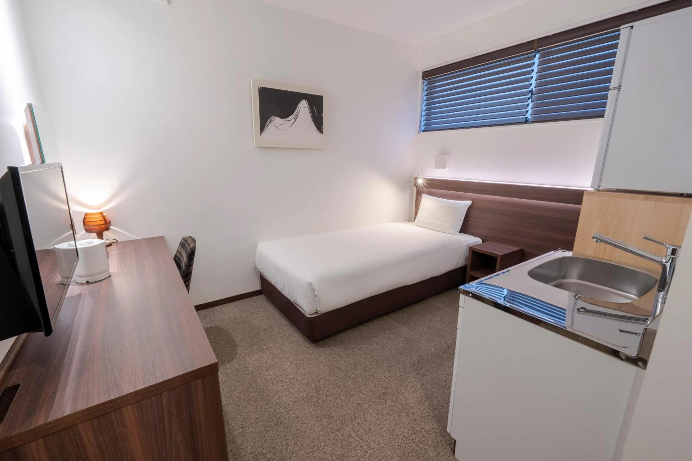 Bed in RESI STAY Jisco Hotel Kyoto Goshonishi