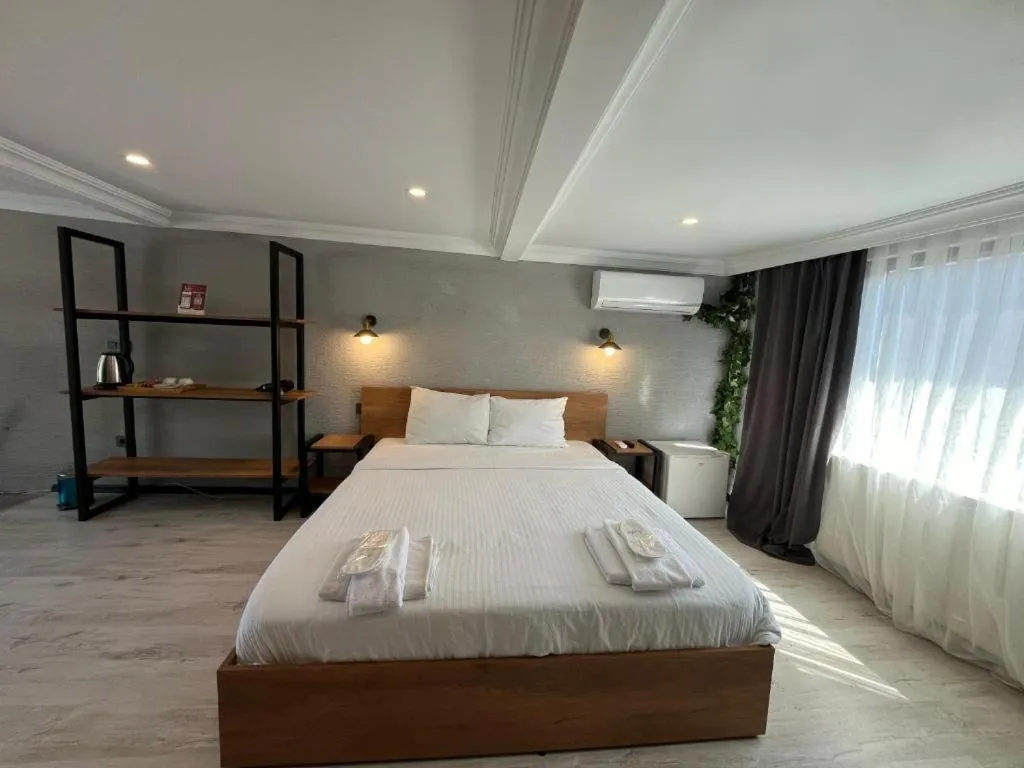 Bed in Le Safran Suite Hotel