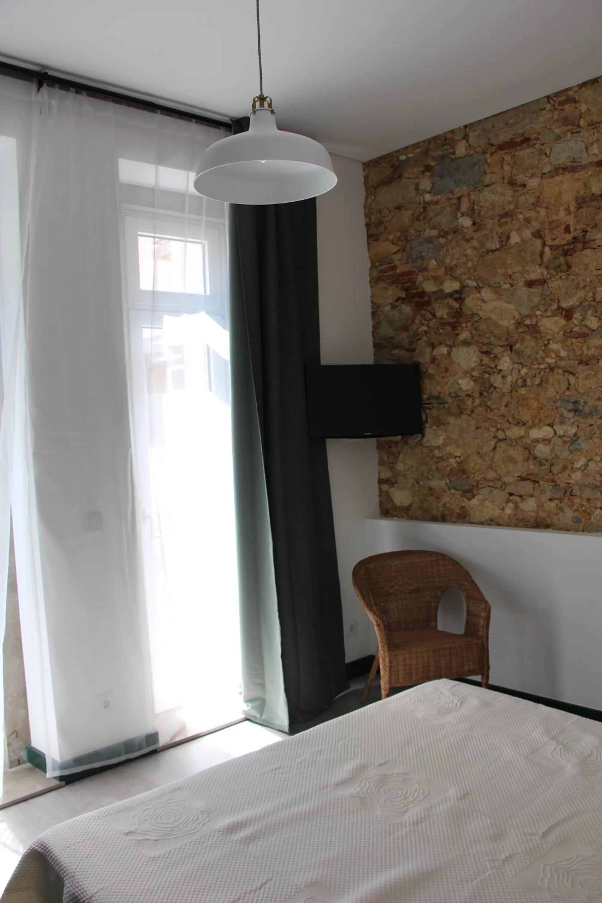 Bed in DoBairro suites at Bairro Alto