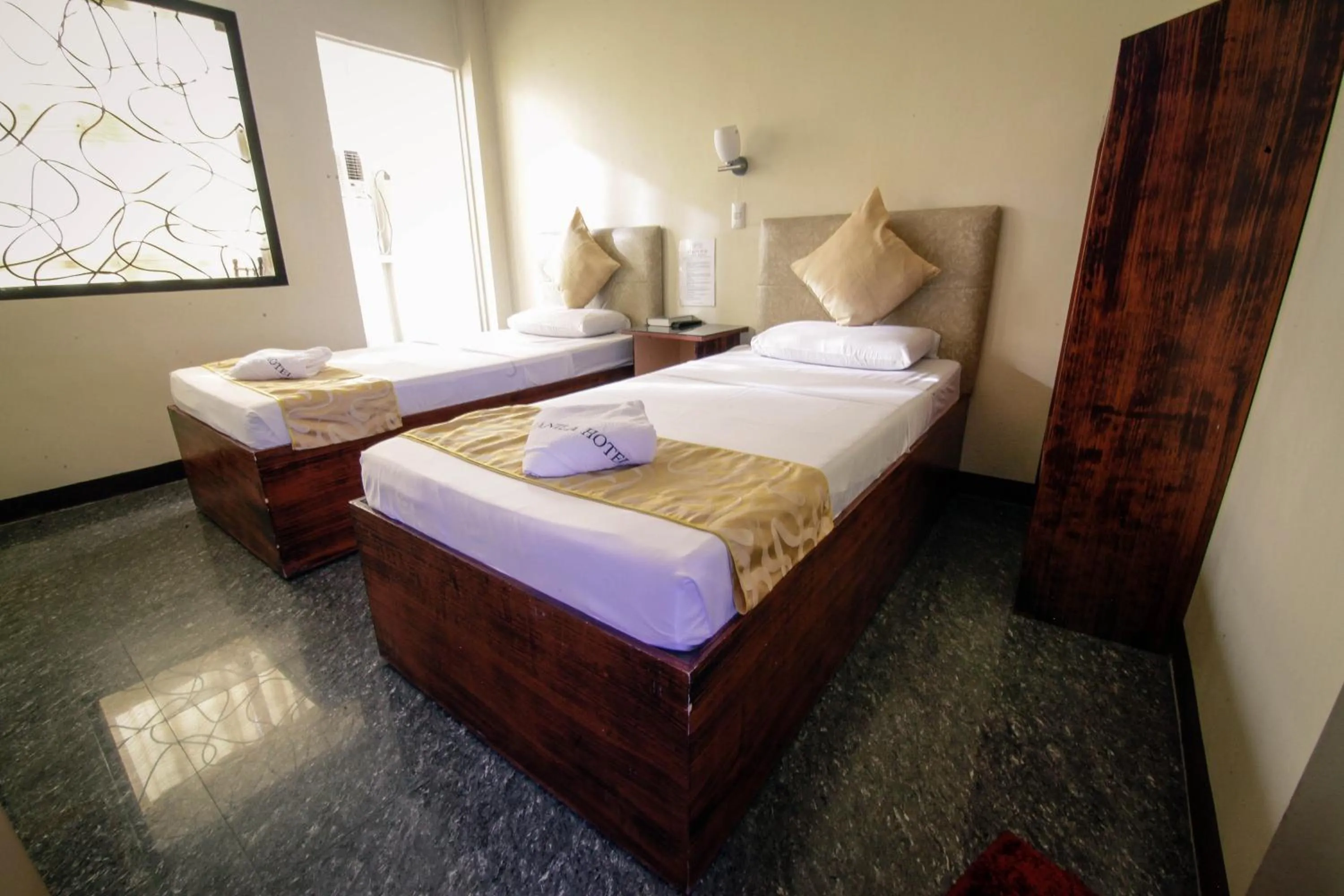 Bed in Fj Manila Hotel