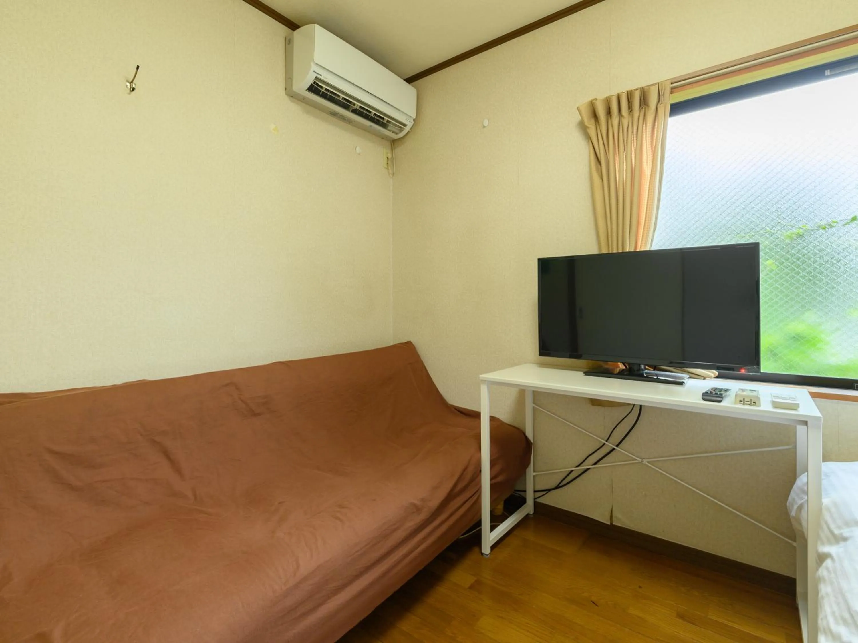 Bed in Tabist Tatsumi Business Hotel Matsusaka