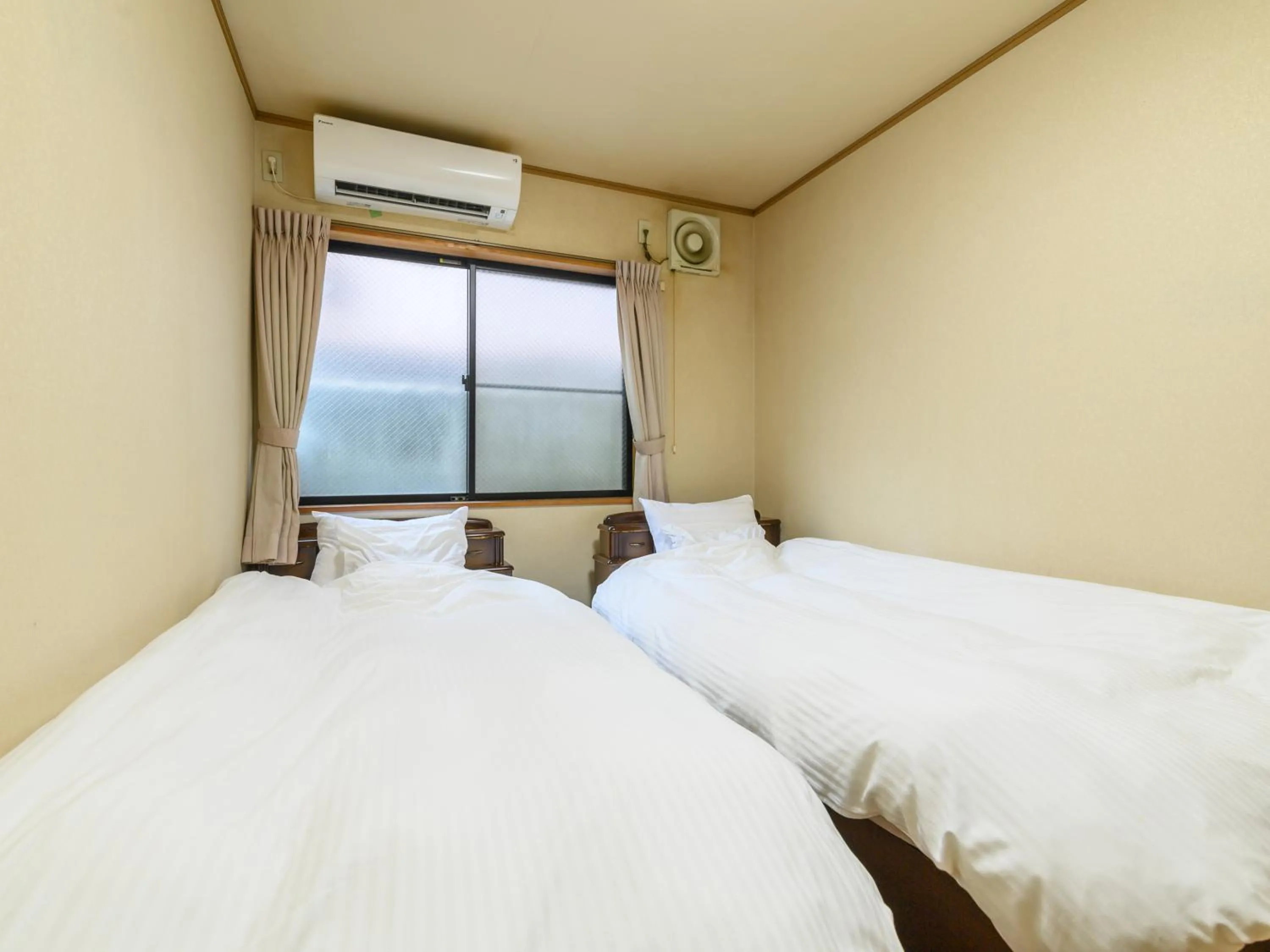 Bed in Tabist Tatsumi Business Hotel Matsusaka