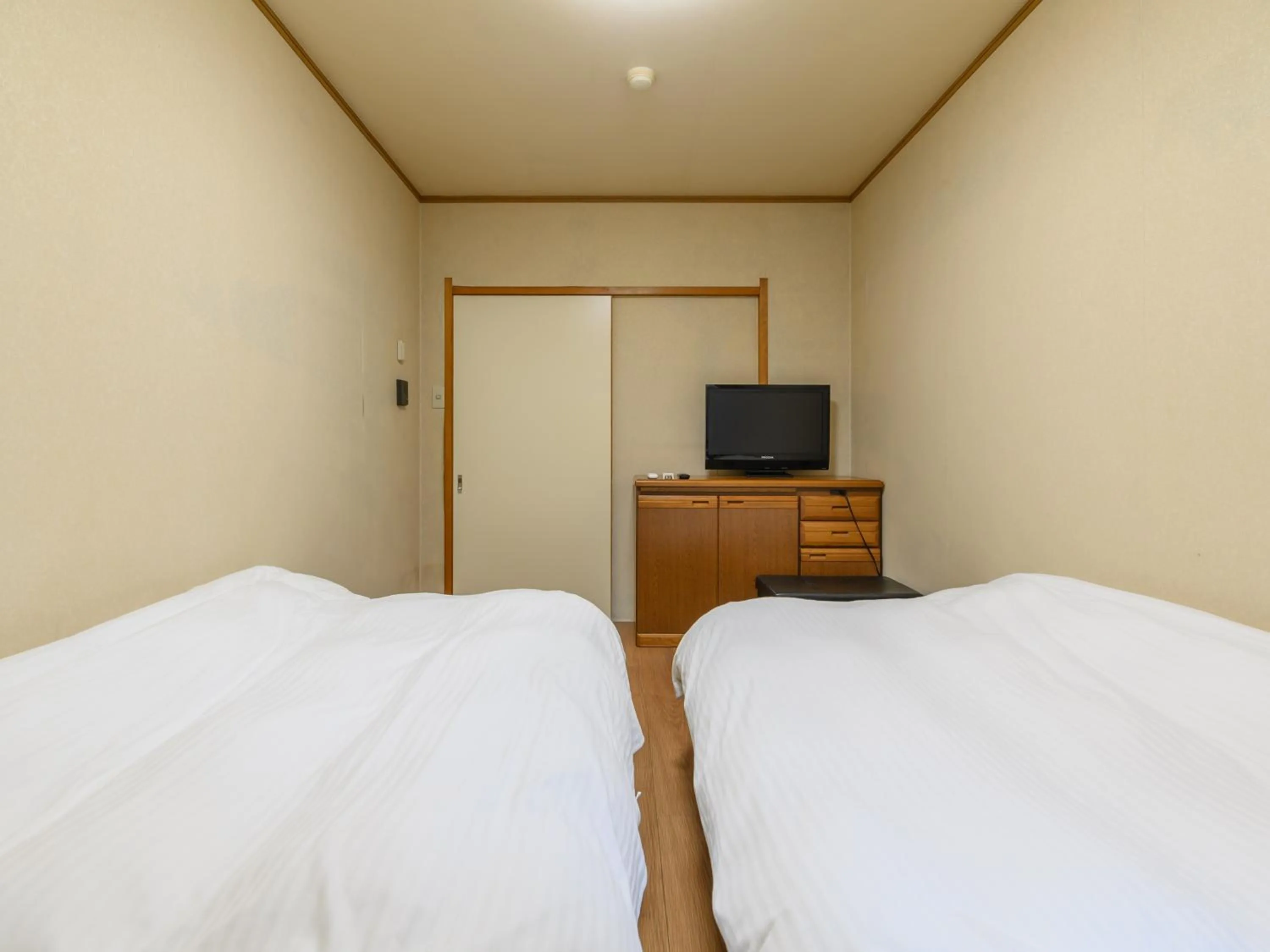 Bed in Tabist Tatsumi Business Hotel Matsusaka
