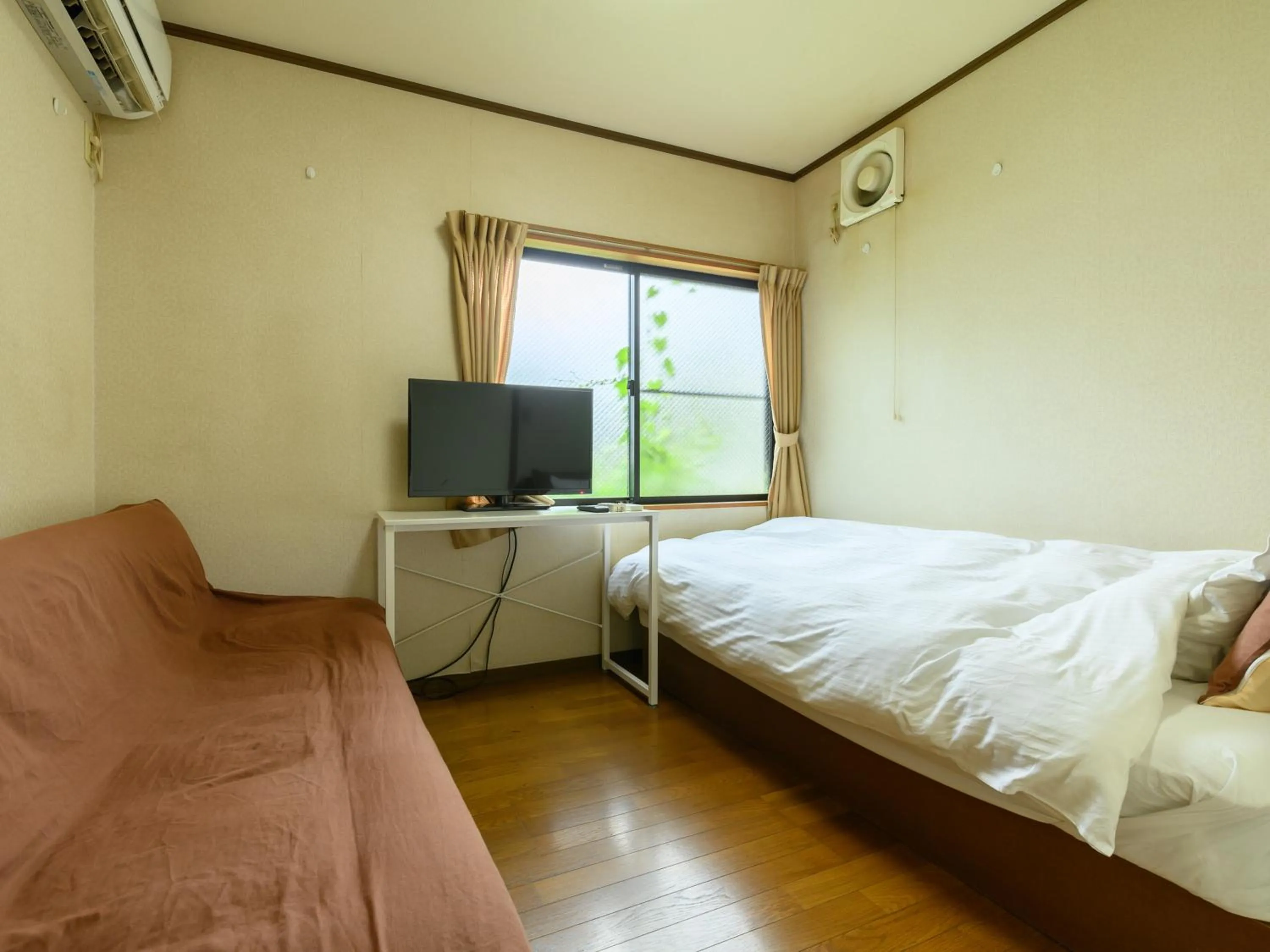 Bed in Tabist Tatsumi Business Hotel Matsusaka