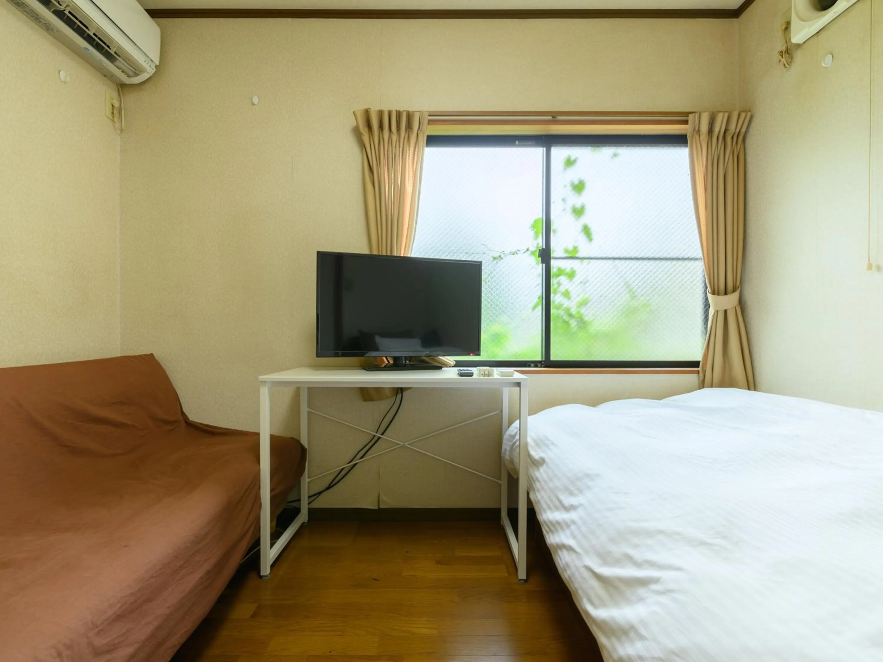 Bed in Tabist Tatsumi Business Hotel Matsusaka