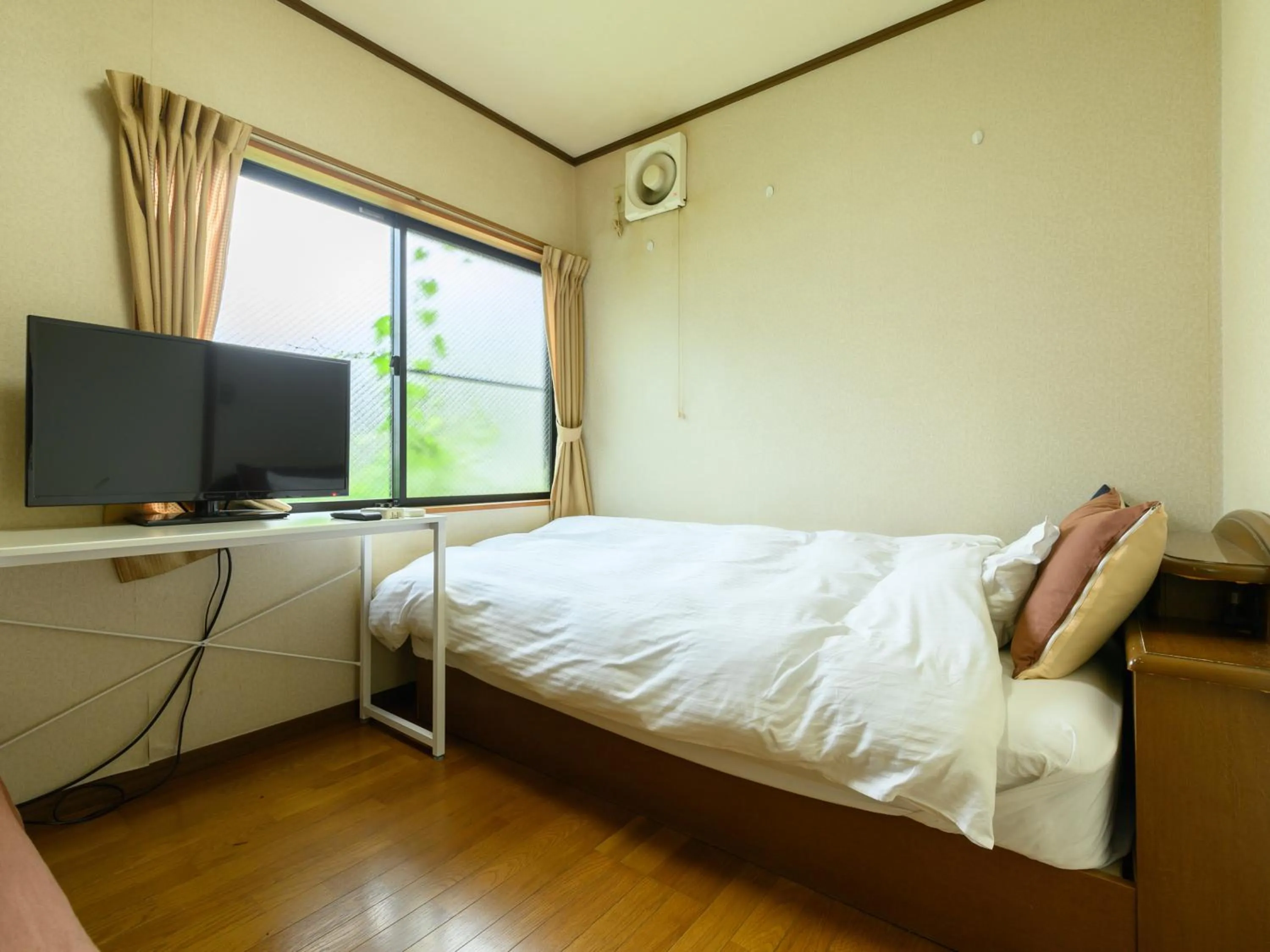 Bed in Tabist Tatsumi Business Hotel Matsusaka