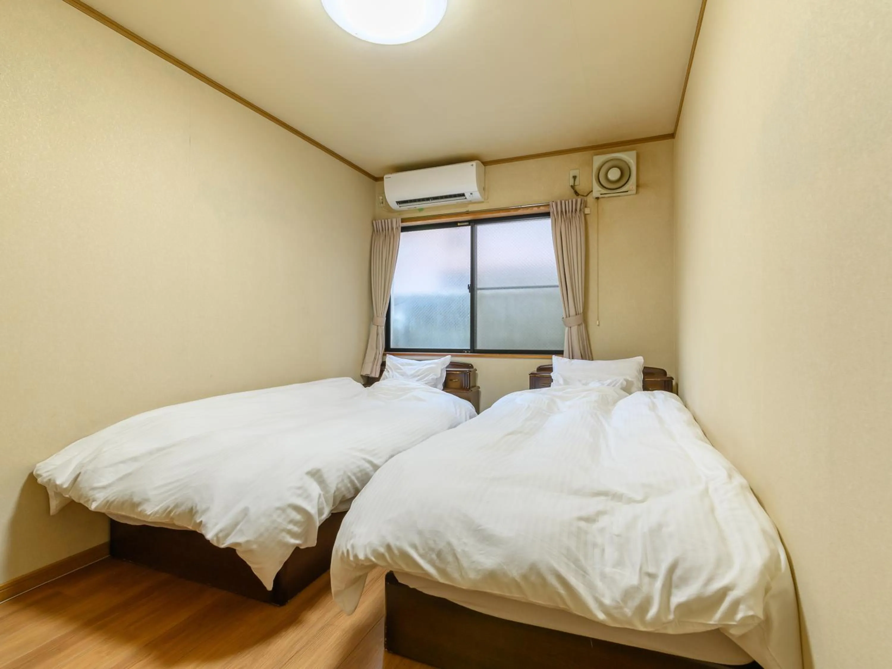 Bed in Tabist Tatsumi Business Hotel Matsusaka