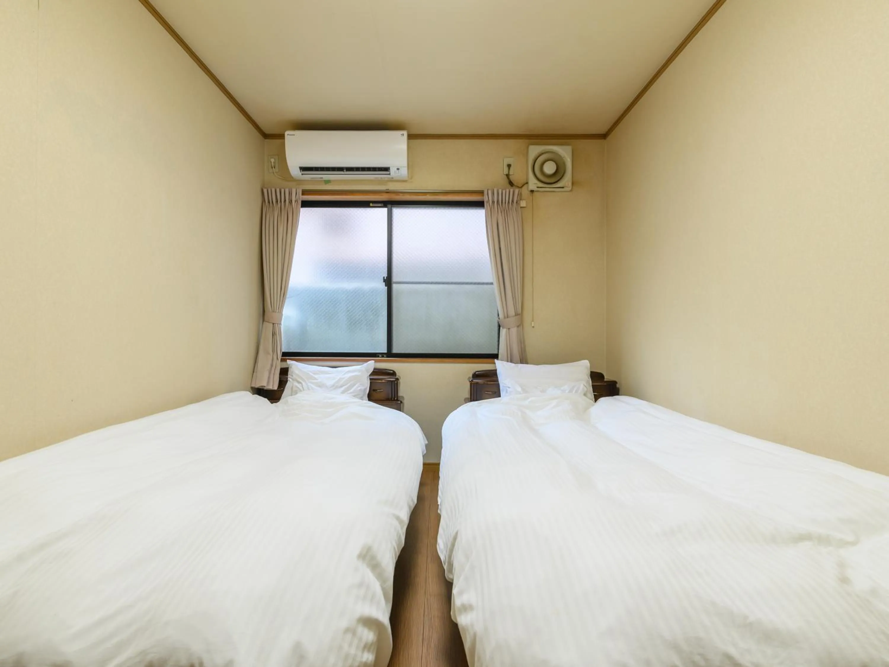 Bed in Tabist Tatsumi Business Hotel Matsusaka