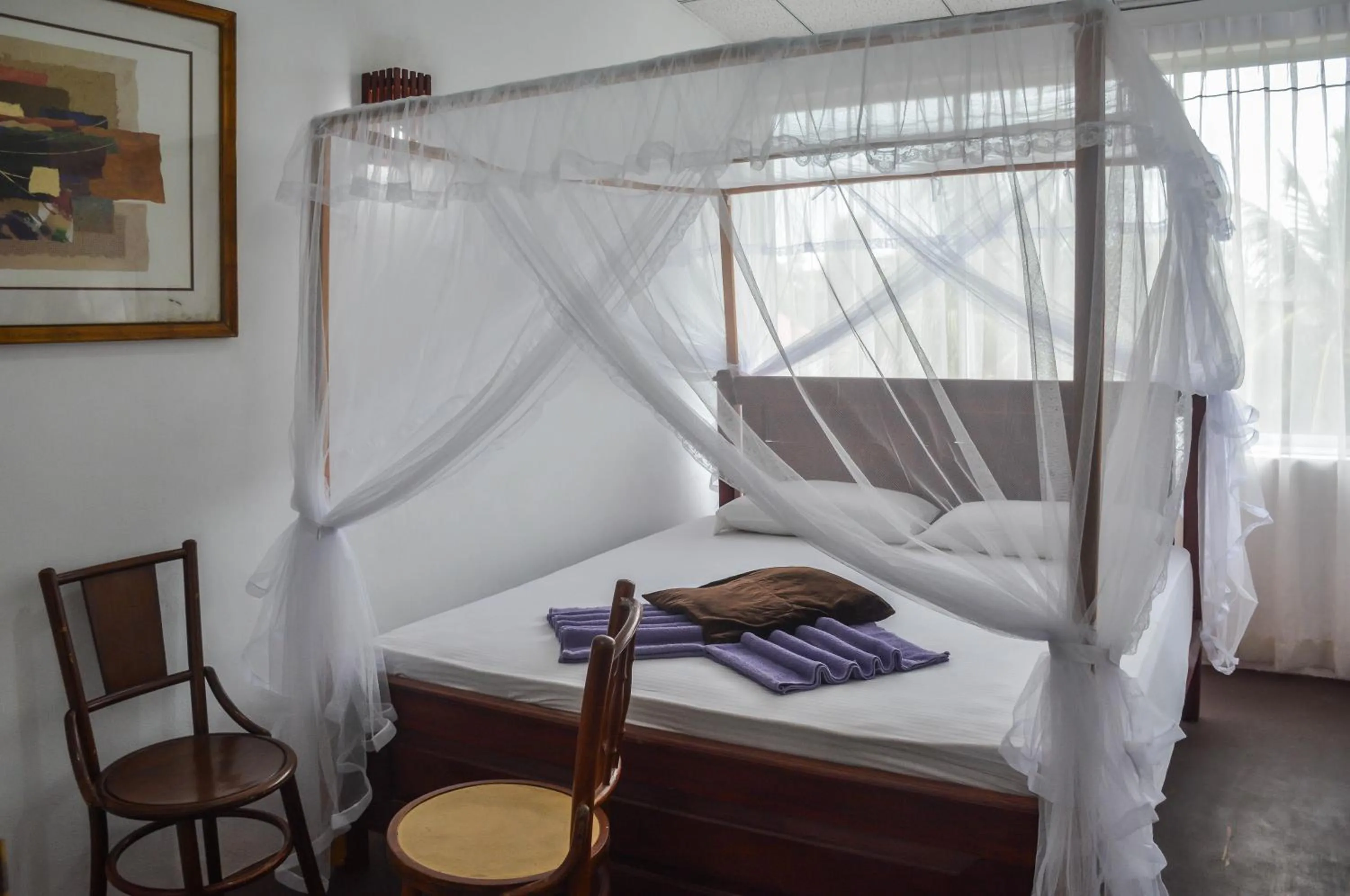 Bed in Blue Horizon Beach Hotel