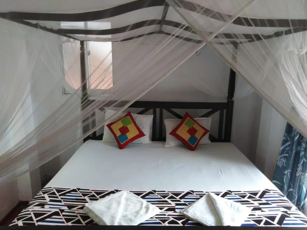 Bed in Blue Horizon Beach Hotel