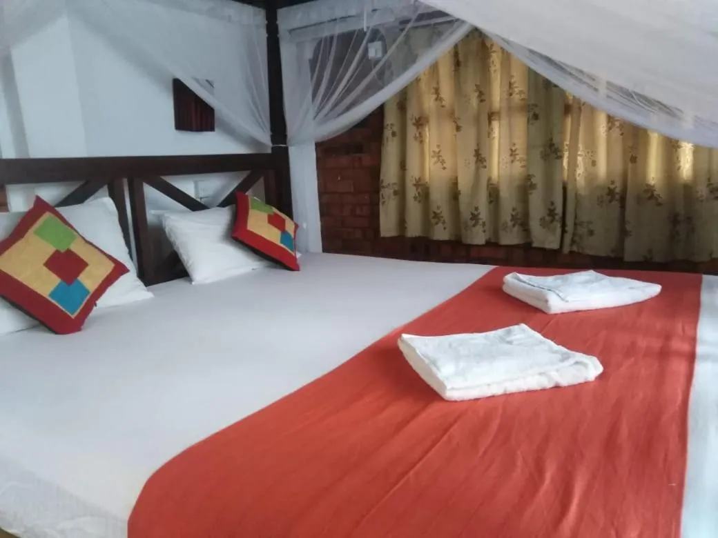 Bed in Blue Horizon Beach Hotel