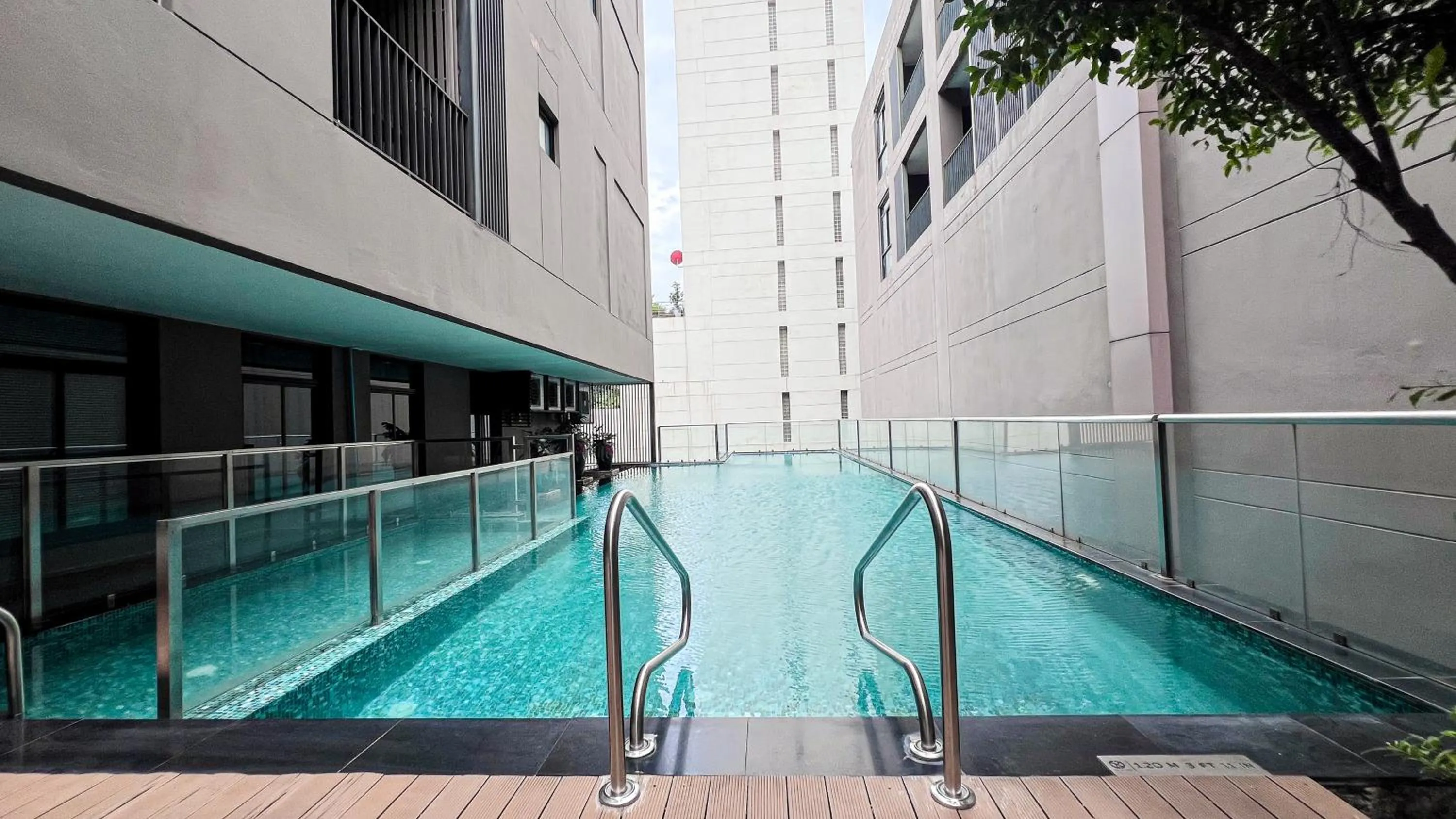 Swimming pool in Metropolis Suites Bangkok, Tapestry Collection by Hilton