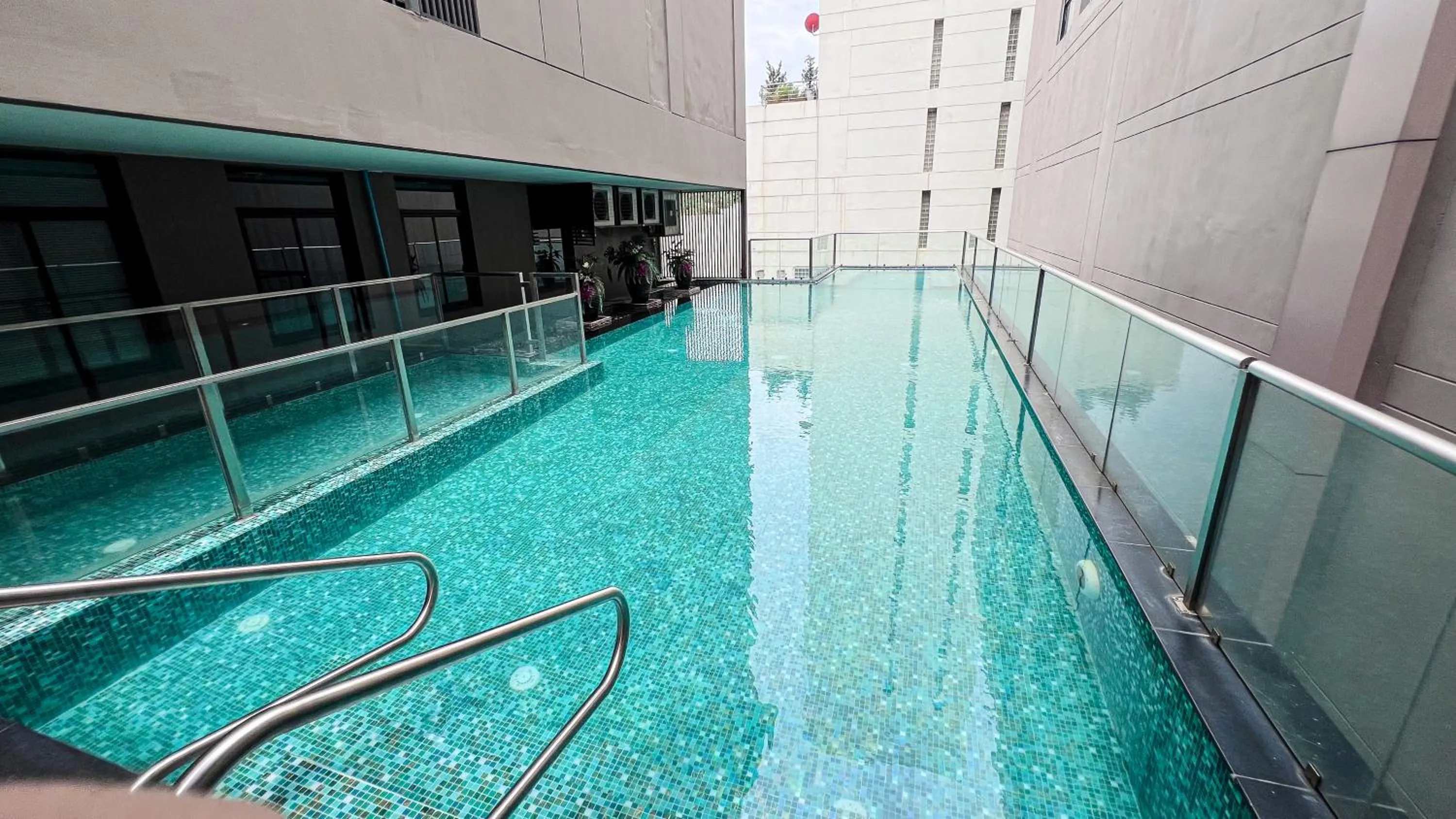 Swimming pool in Metropolis Suites Bangkok, Tapestry Collection by Hilton