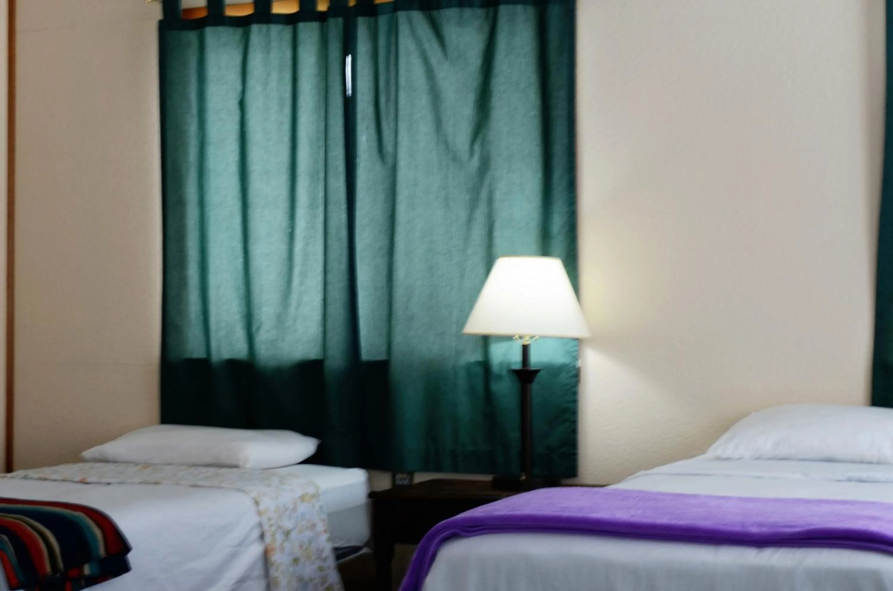 Bed in Little River Inn Motel