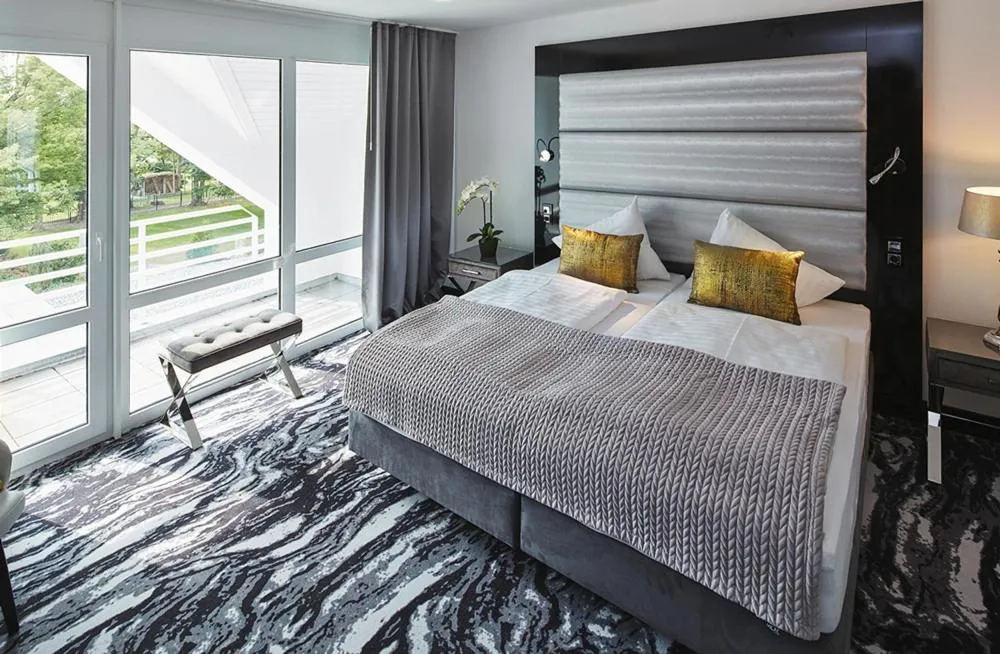 Bed in Kurhaus Design Boutique Hotel