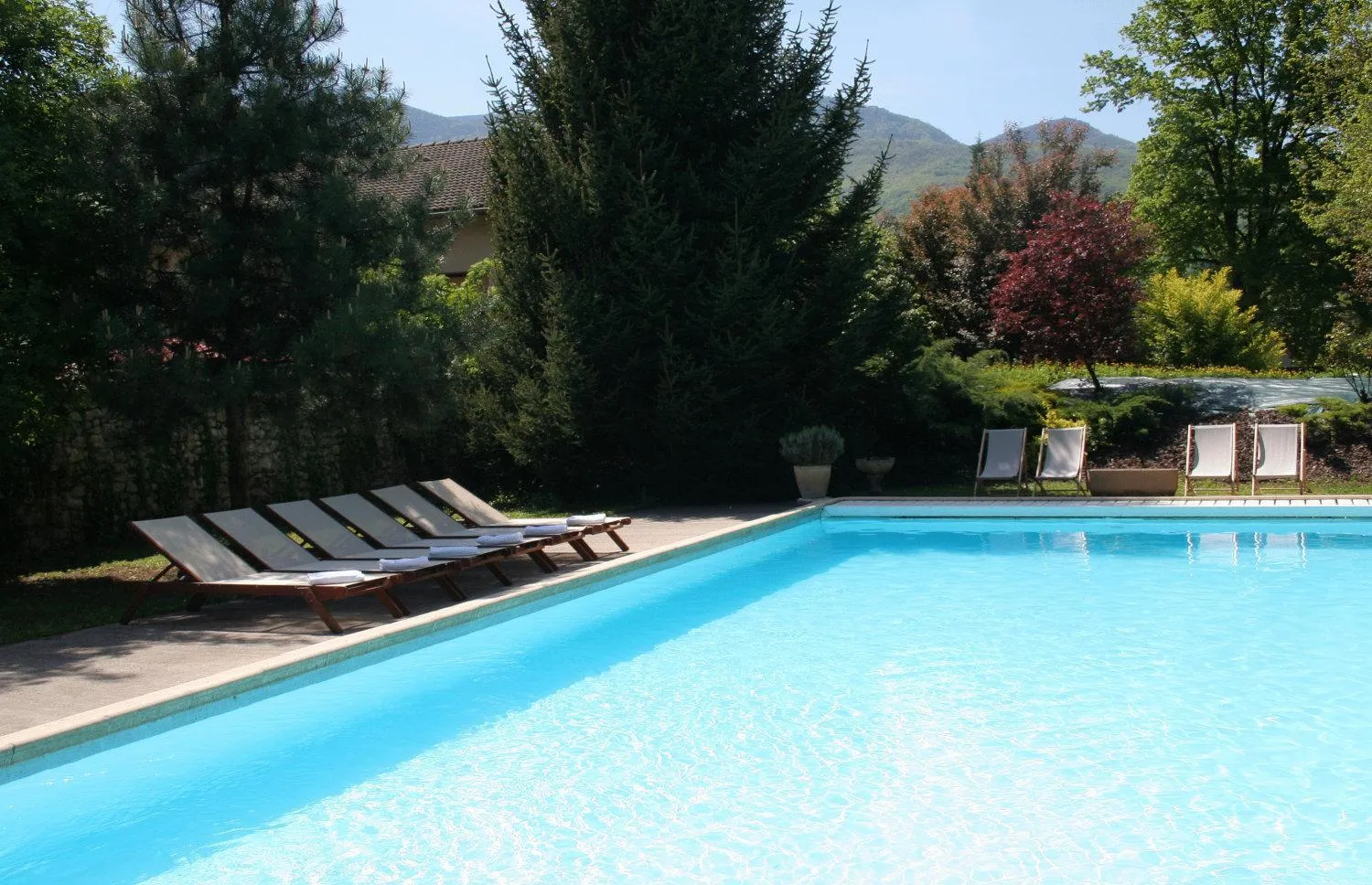 Pool view in Logis Hôtel Restaurant Le Castel Fleuri