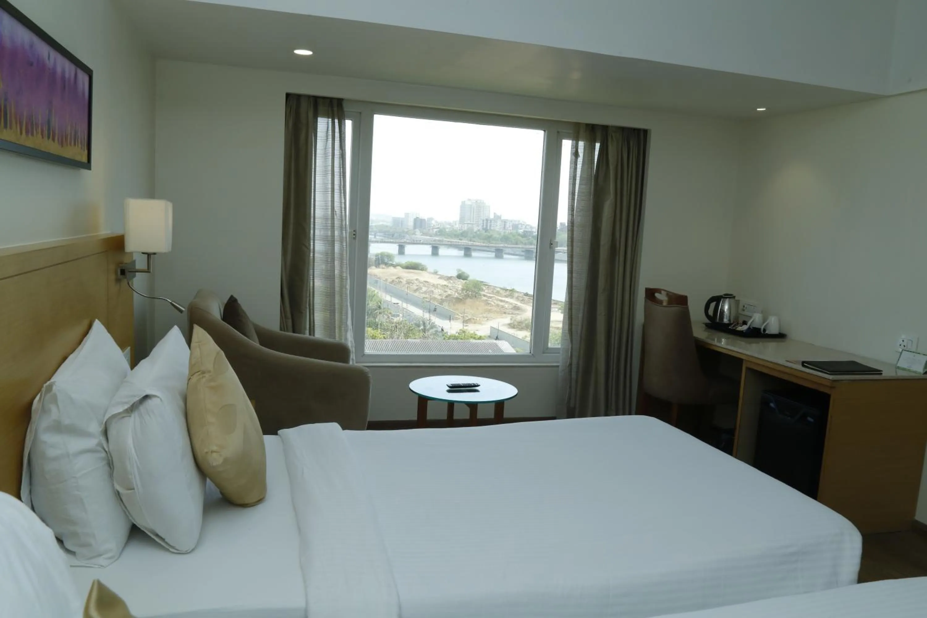 Bed in Sarovar Portico Rivera Ahmedabad