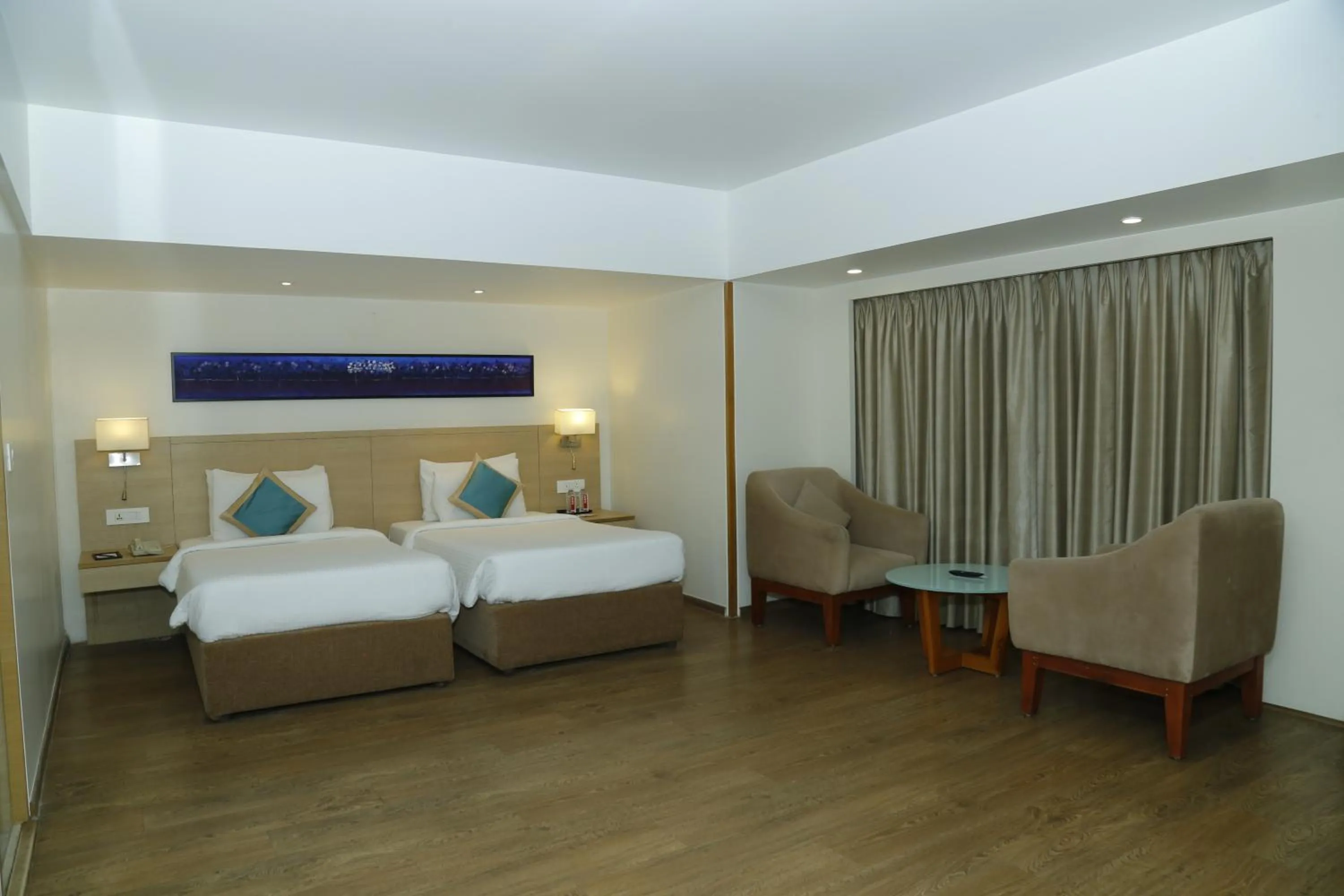 Bed in Sarovar Portico Rivera Ahmedabad