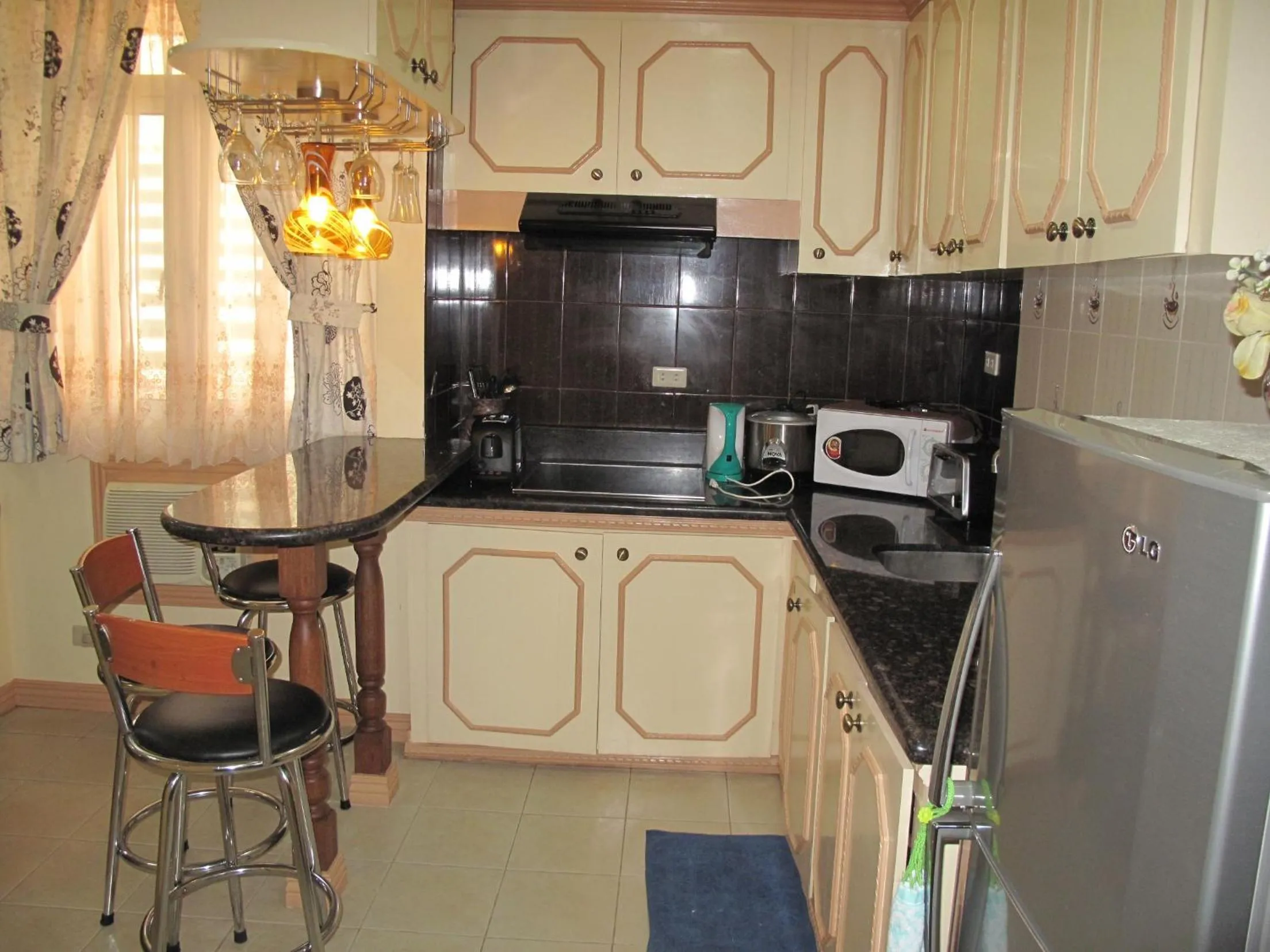 Kitchen or kitchenette in Makati Suites at Travelers Inn