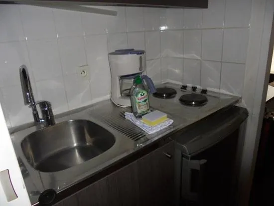 Kitchen or kitchenette in La Voisina Hotel