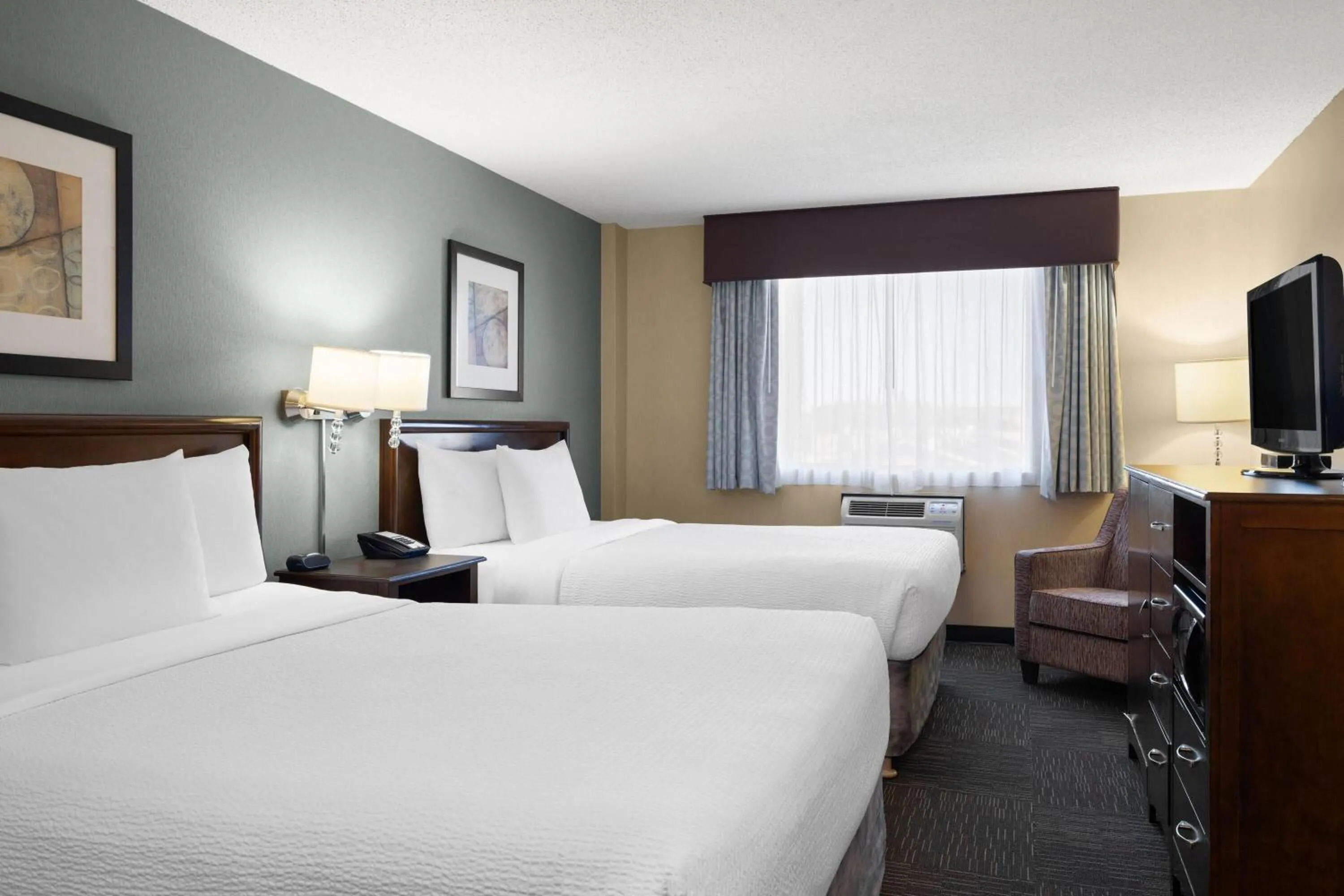Photo of the whole room, Bed in Ramada by Wyndham Saskatoon