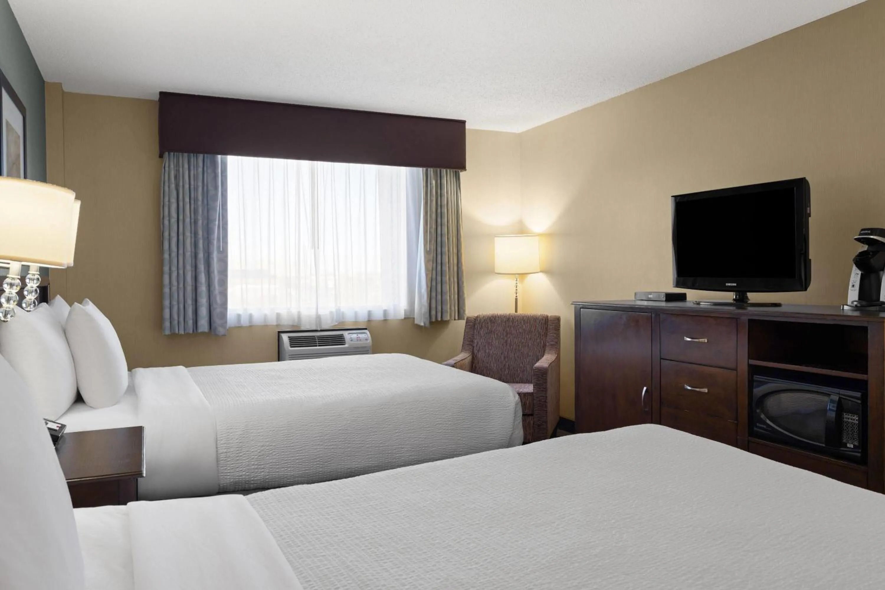 Photo of the whole room, Bed in Ramada by Wyndham Saskatoon